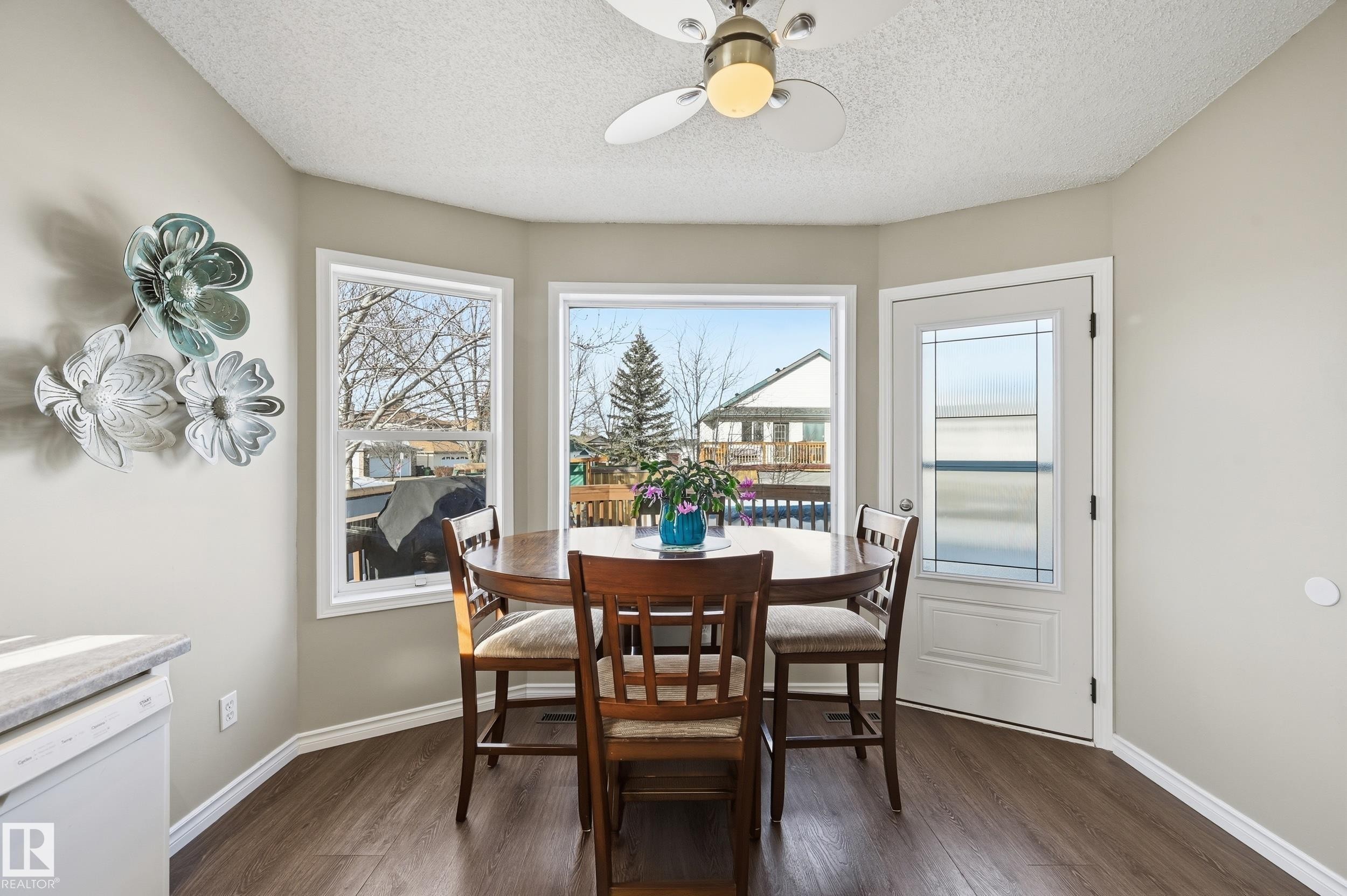 Dining area with a ceiling fan, dark wood-type flooring, and a textured ceiling - 2952 39 Avenue, Edmonton, AB - Indoor Photo Showing Dining Room