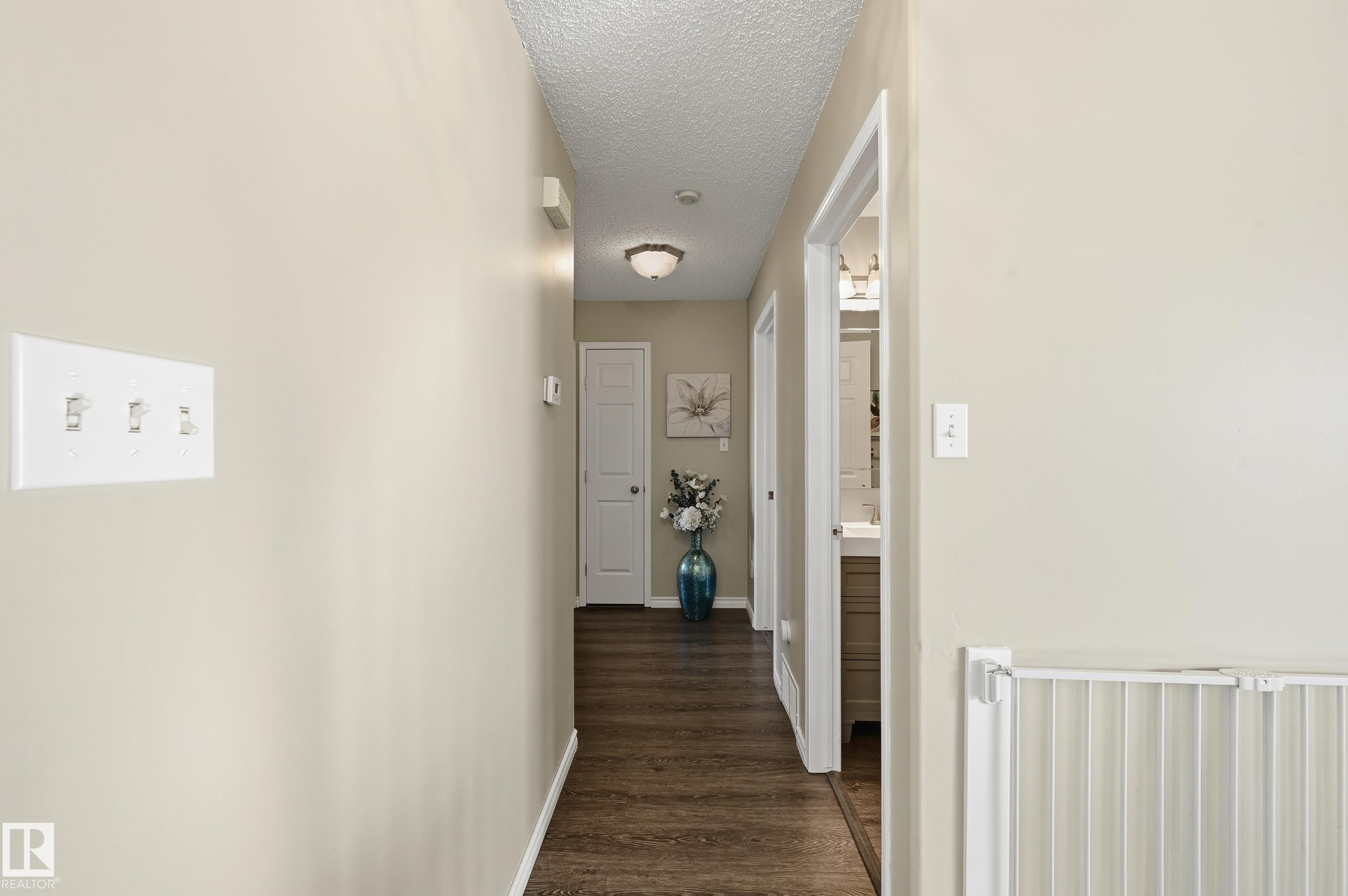Hall with dark wood-type flooring and a textured ceiling - 2952 39 Avenue, Edmonton, AB - Indoor Photo Showing Other Room