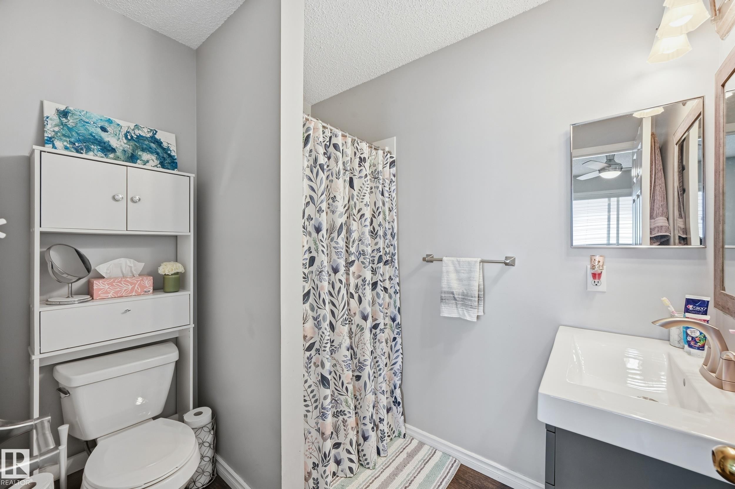 Full bath with a shower with shower curtain, vanity, a textured ceiling, and ceiling fan - 2952 39 Avenue, Edmonton, AB - Indoor Photo Showing Bathroom