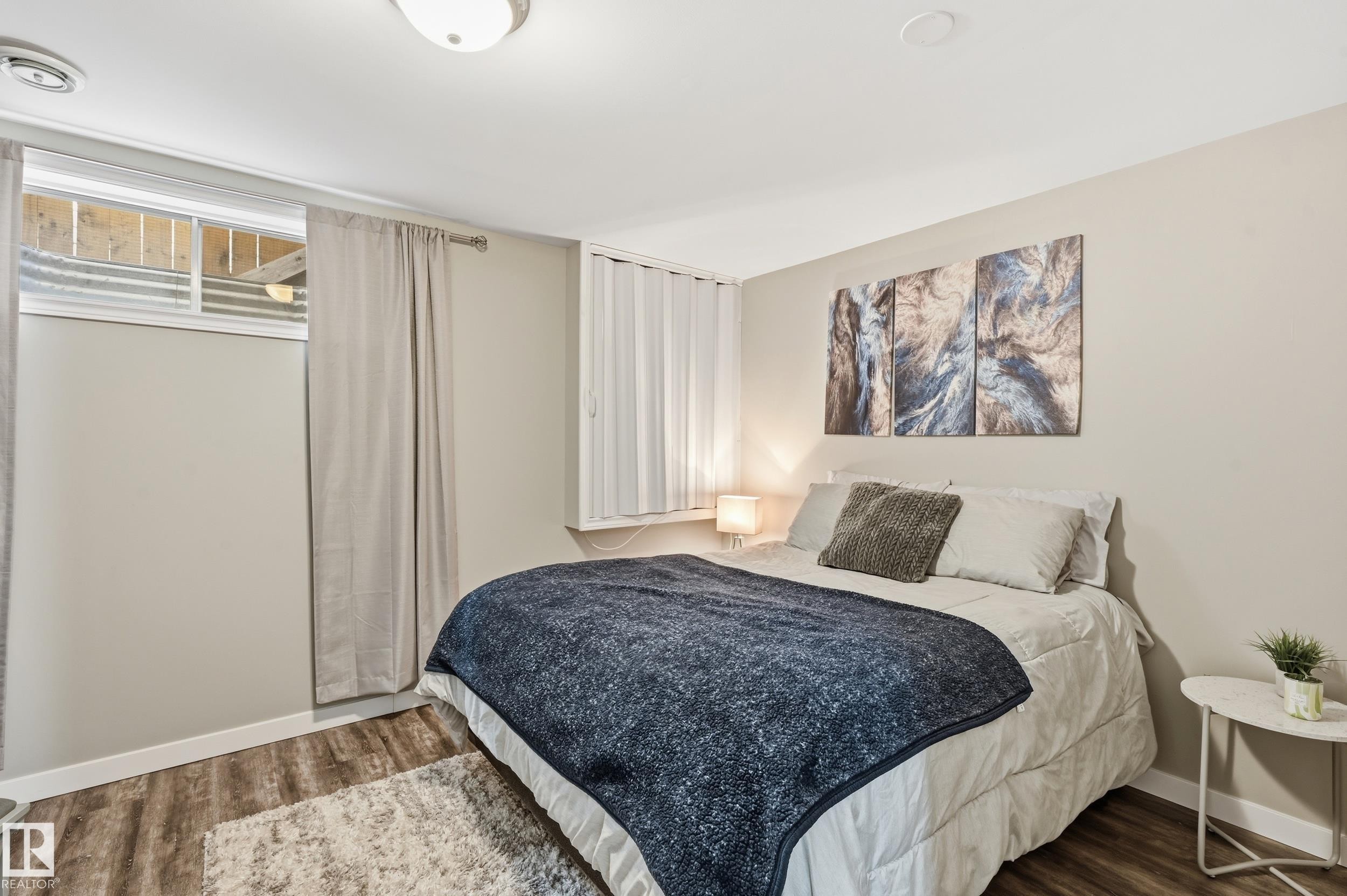 Bedroom with wood finished floors and baseboards - 2952 39 Avenue, Edmonton, AB - Indoor Photo Showing Bedroom