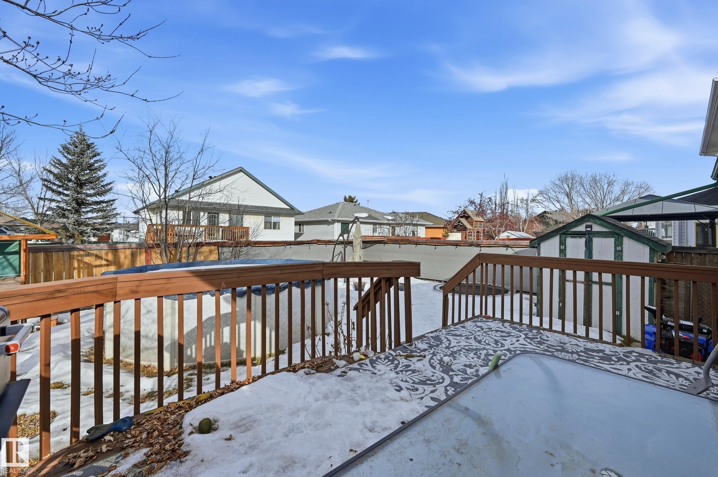Snow covered deck featuring a residential view and a storage shed - 2952 39 Avenue, Edmonton, AB - Outdoor