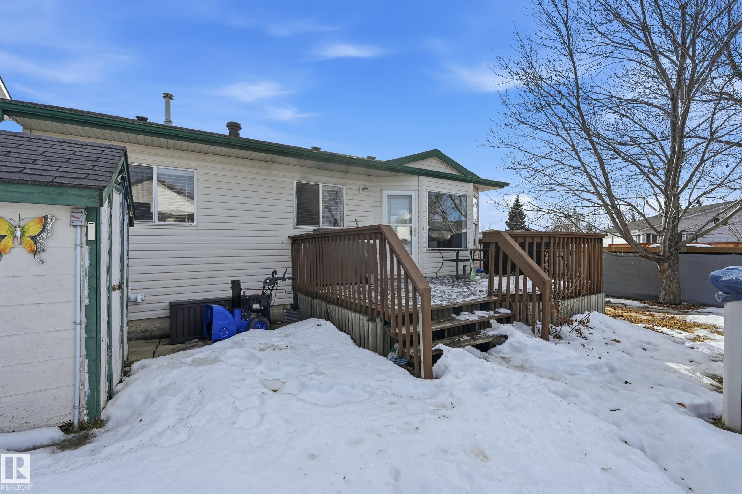 Snow covered back of property with a wooden deck - 2952 39 Avenue, Edmonton, AB - Outdoor With Exterior