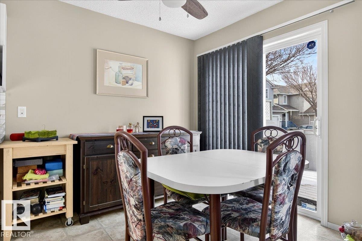 Dining area featuring ceiling fan and a textured ceiling - 23 4020 21 Street, Edmonton, AB - Indoor Photo Showing Dining Room