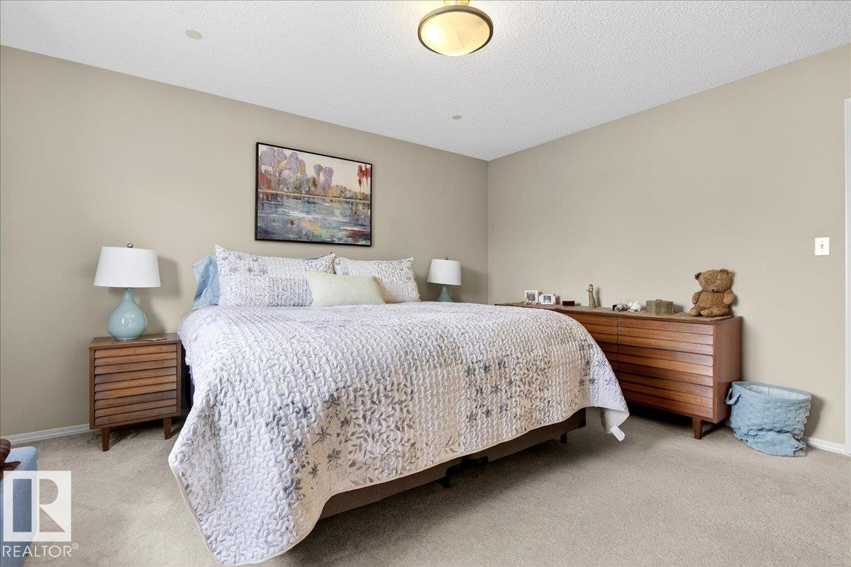 Carpeted bedroom with baseboards and a textured ceiling - 23 4020 21 Street, Edmonton, AB - Indoor Photo Showing Bedroom