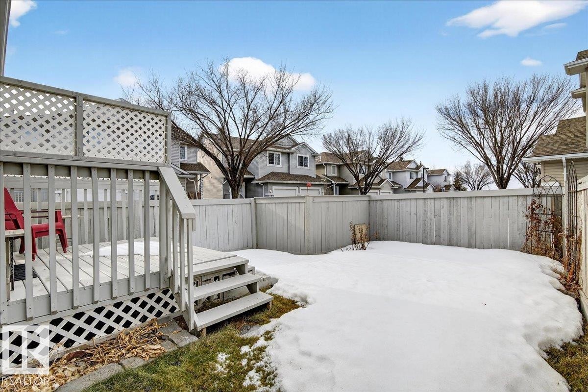 Fenced backyard featuring a residential view and a wooden deck - 23 4020 21 Street, Edmonton, AB - Outdoor