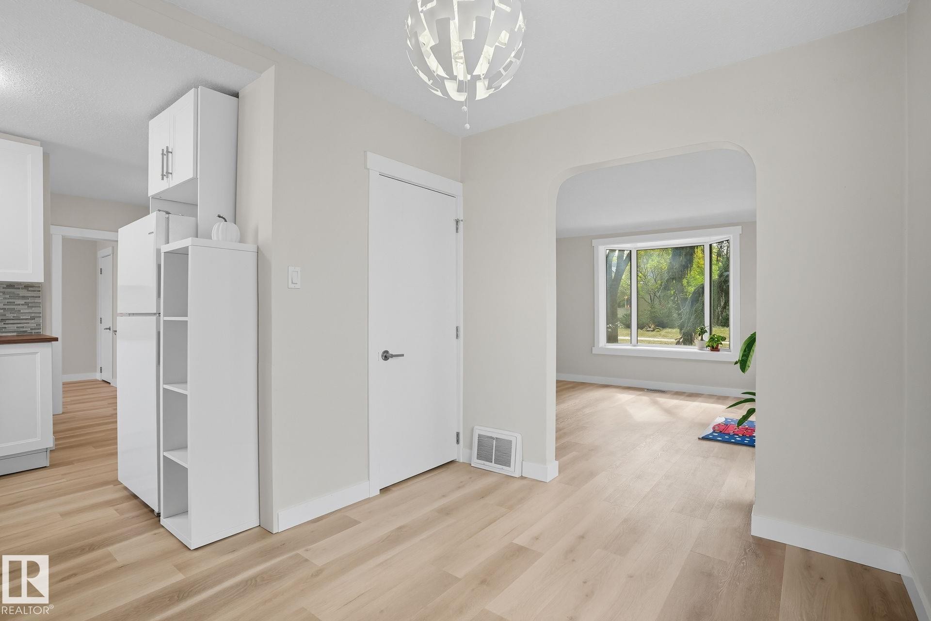 Interior space featuring light wood-type flooring and a chandelier - 11222 71 Avenue, Edmonton, AB - Indoor Photo Showing Other Room