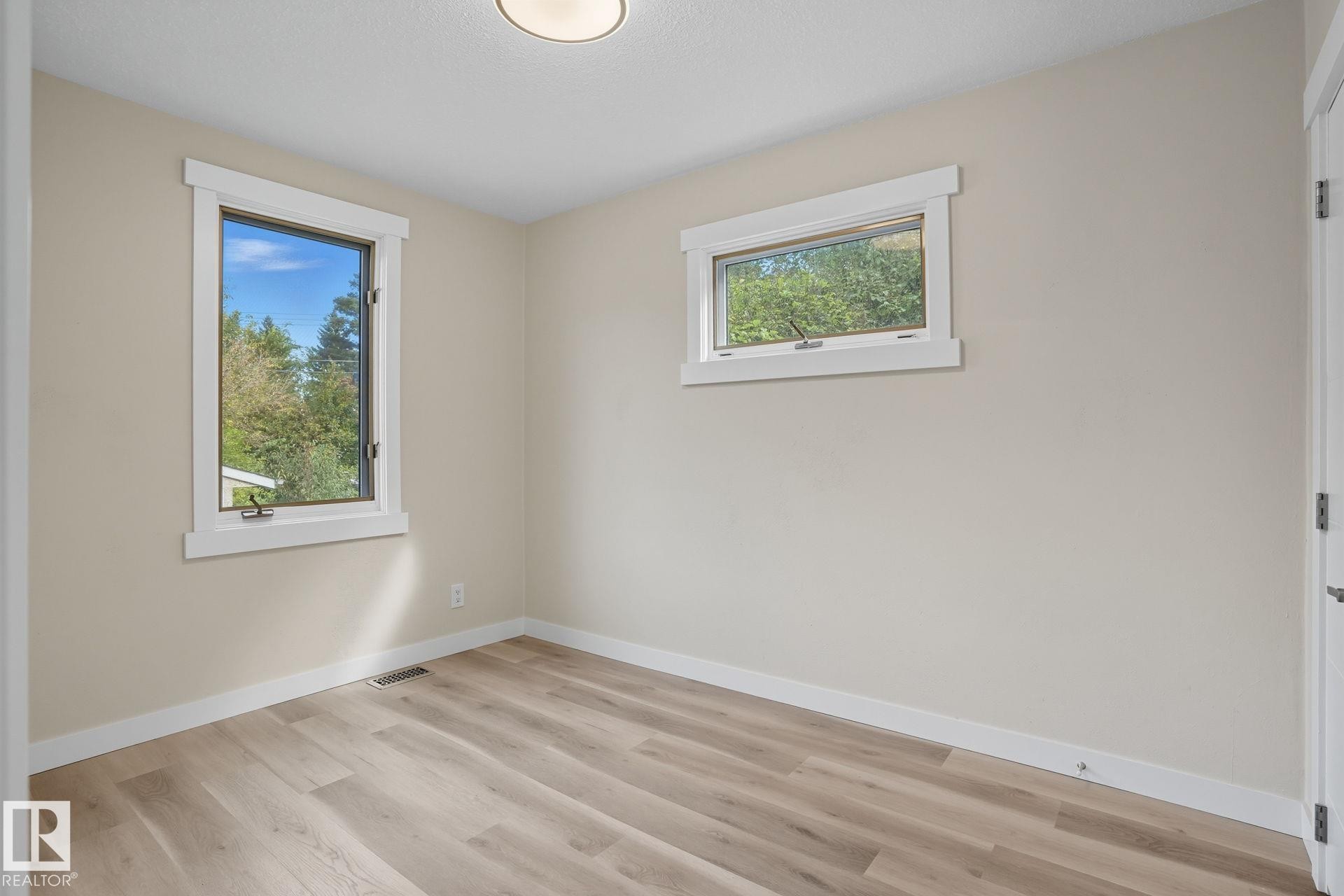 Empty room with baseboards and light wood finished floors - 11222 71 Avenue, Edmonton, AB - Indoor Photo Showing Other Room