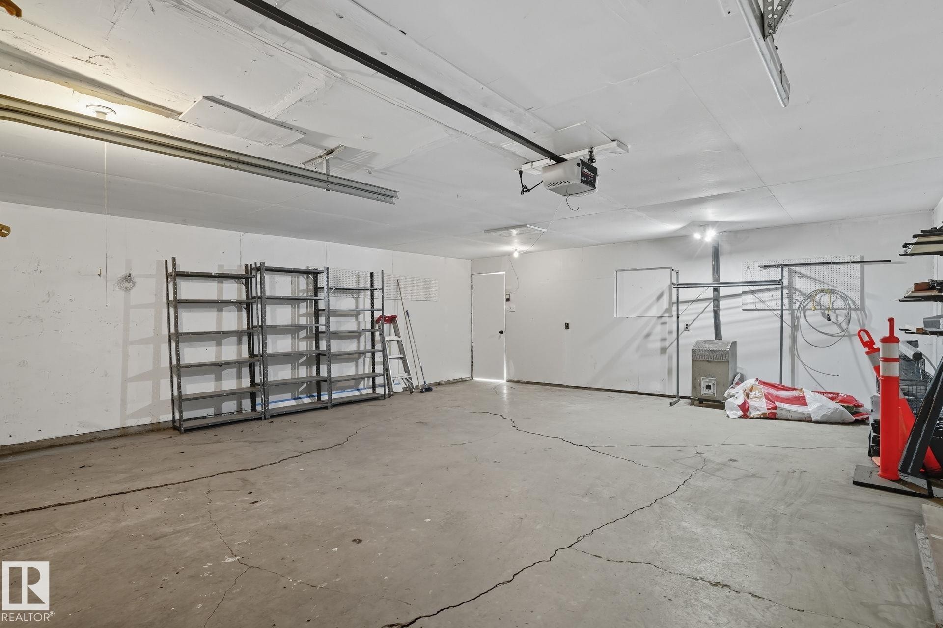 Garage featuring a garage door opener - 11222 71 Avenue, Edmonton, AB - Indoor Photo Showing Garage