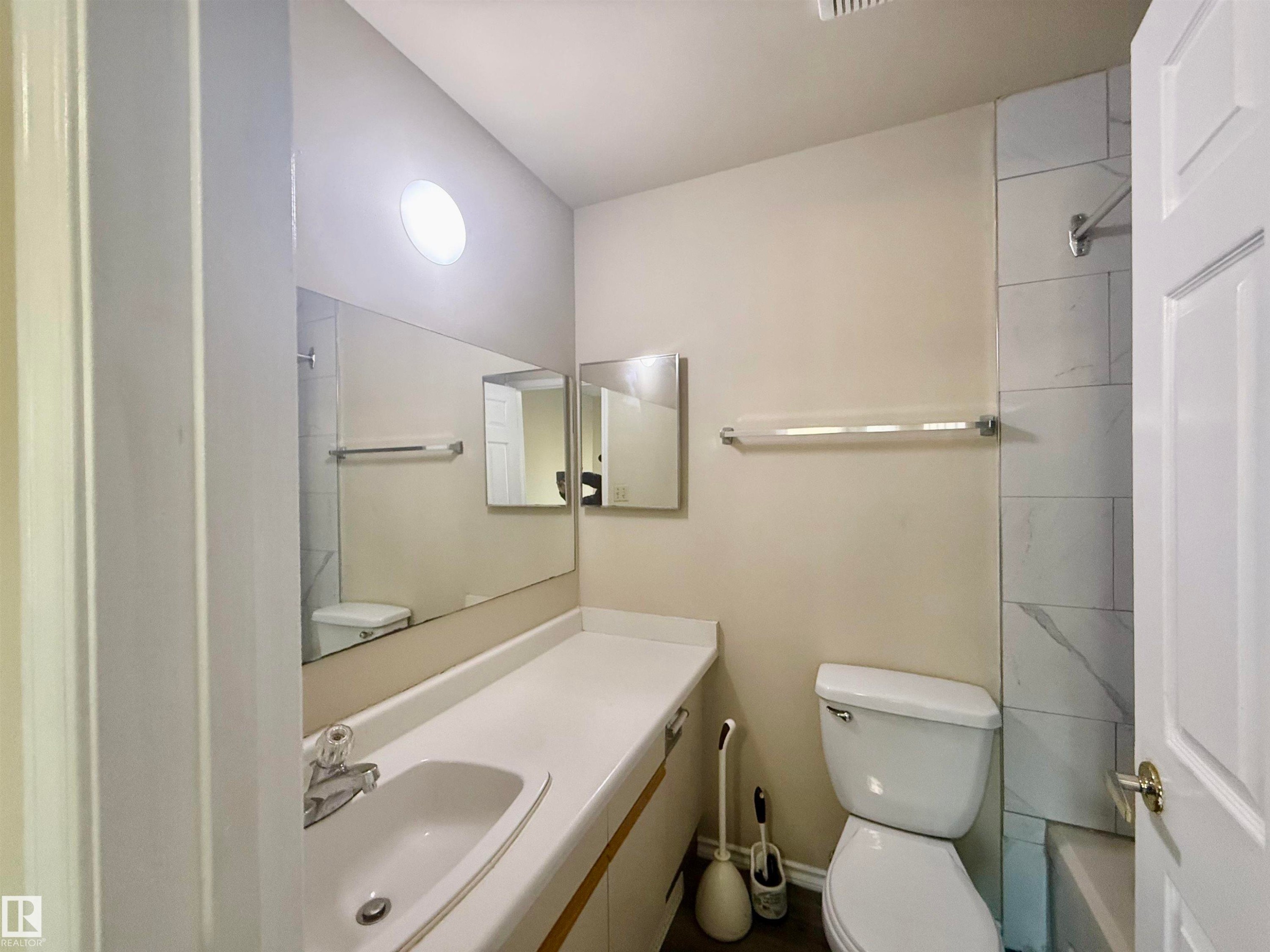 Bathroom featuring vanity and washtub / shower combination - 10905 74 Avenue, Edmonton, AB - Indoor Photo Showing Bathroom