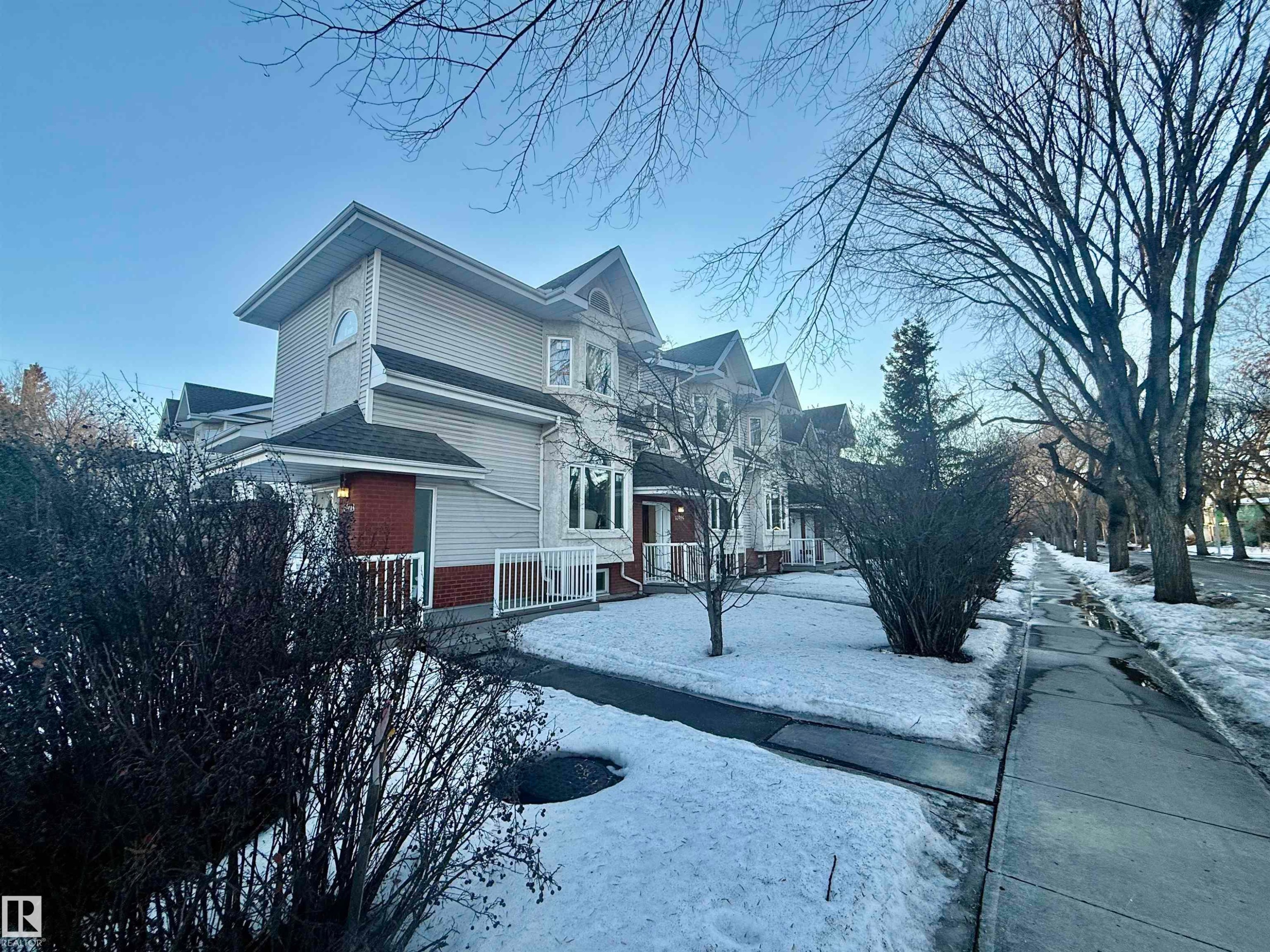 View of snowy exterior with brick siding and a residential view - 10905 74 Avenue, Edmonton, AB - Outdoor