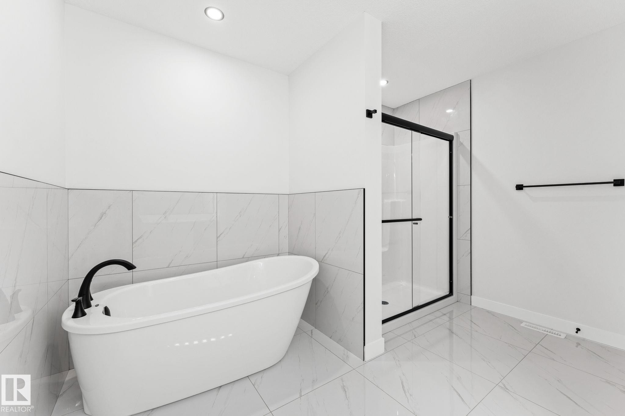 Full bathroom with a stall shower, a soaking tub, marble finish floors, and recessed lighting - 3 Pierwyck Loop, Spruce Grove, AB - Indoor Photo Showing Bathroom