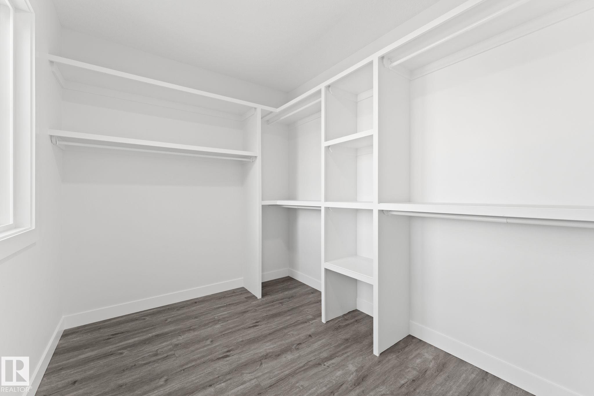 Walk in closet featuring dark wood finished floors - 3 Pierwyck Loop, Spruce Grove, AB - Indoor With Storage