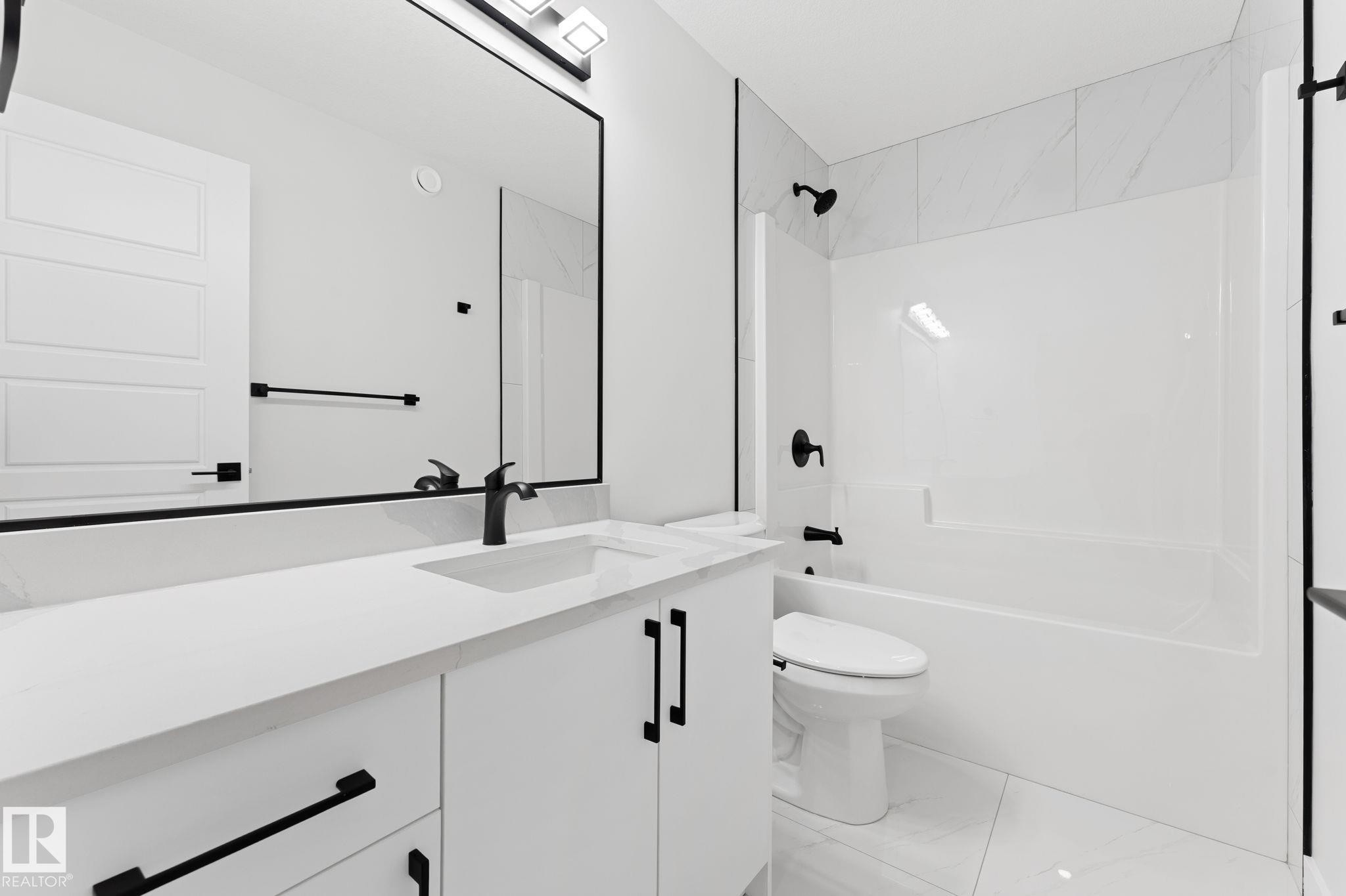 Full bathroom featuring vanity, shower / washtub combination, and light marble finish floors - 3 Pierwyck Loop, Spruce Grove, AB - Indoor Photo Showing Bathroom