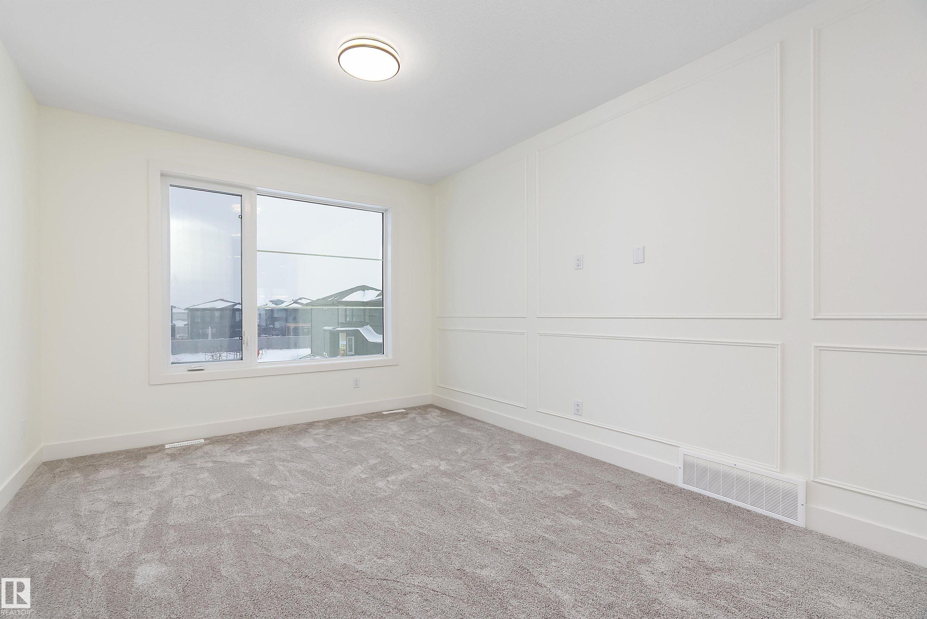 Carpeted spare room featuring a decorative wall - Edmonton, AB - Indoor Photo Showing Other Room