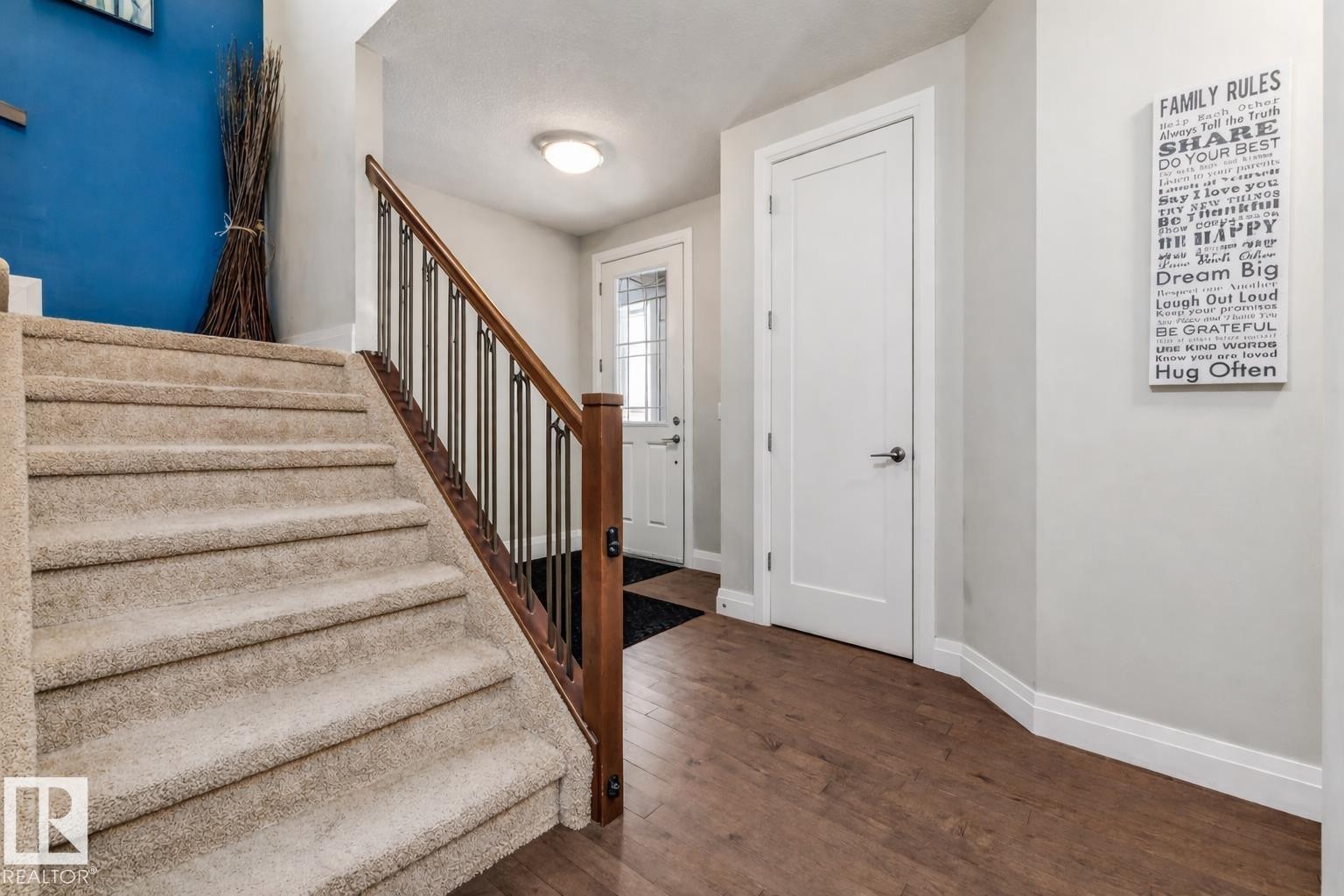 Stairway with baseboards and hardwood / wood-style flooring - 14 Spring Bay, Spruce Grove, AB - Indoor Photo Showing Other Room