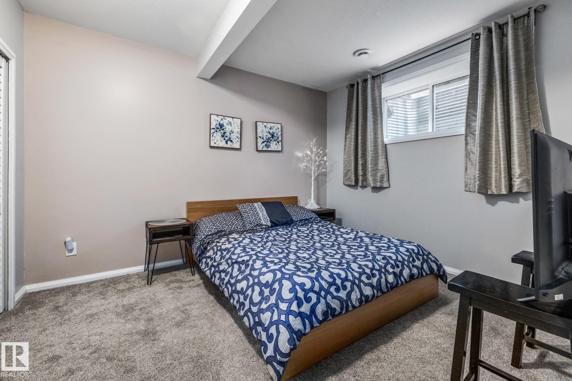 Bedroom featuring carpet floors and beam ceiling - 14 Spring Bay, Spruce Grove, AB - Indoor Photo Showing Bedroom