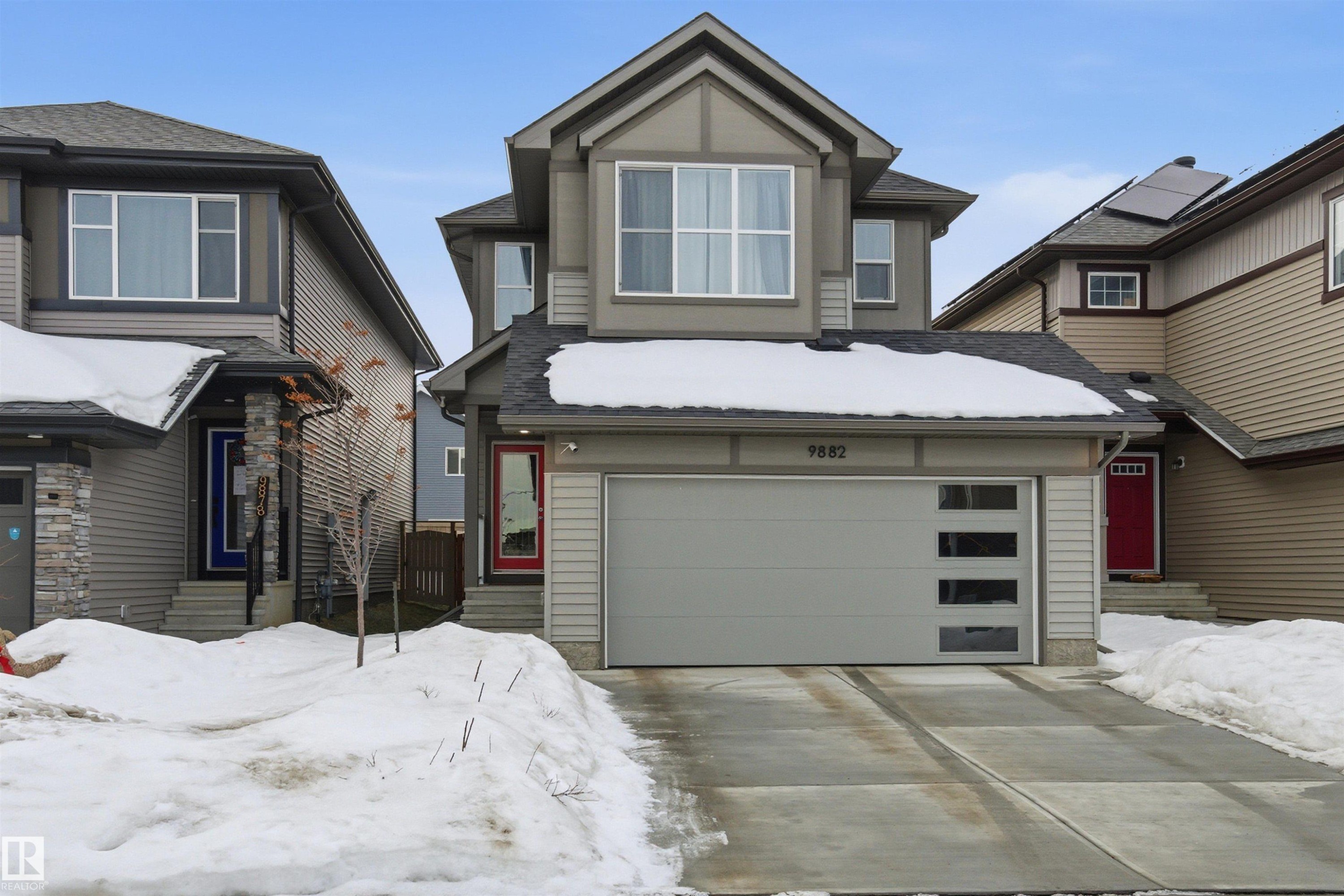 View of front of home with a garage, entry steps, driveway, and a shingled roof - 9882 225A St Nw, Edmonton, AB - Outdoor With Facade