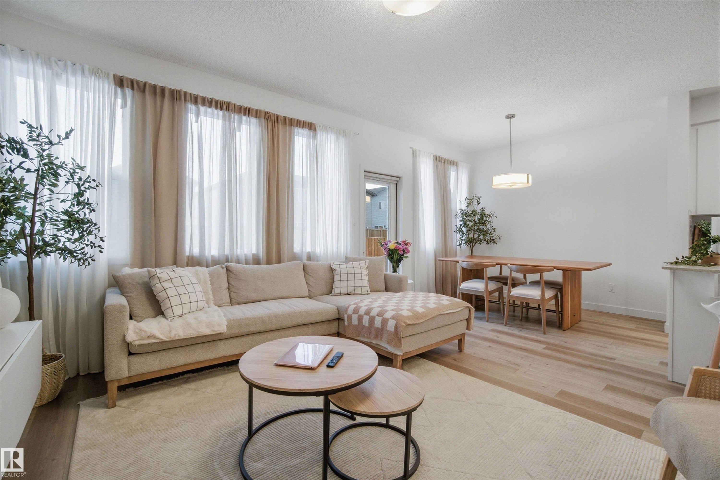 Living room with light wood-style floors and a textured ceiling - 9882 225A St Nw, Edmonton, AB - Indoor Photo Showing Living Room