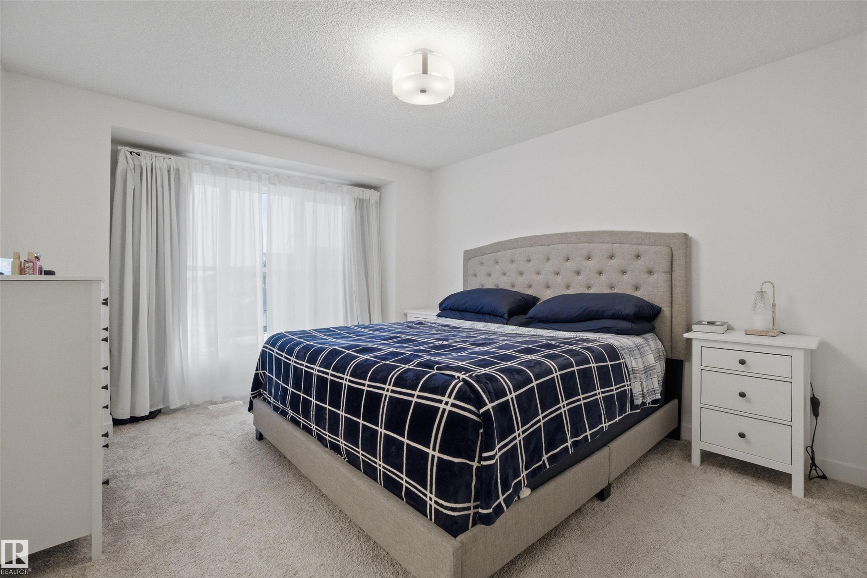 Bedroom with light colored carpet and a textured ceiling - 9882 225A St Nw, Edmonton, AB - Indoor Photo Showing Bedroom