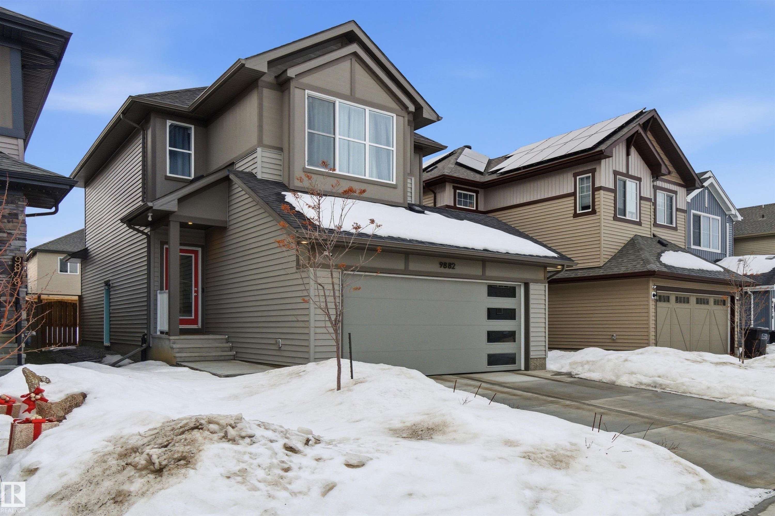 View of front of home featuring a garage and roof mounted solar panels - 9882 225A St Nw, Edmonton, AB - Outdoor