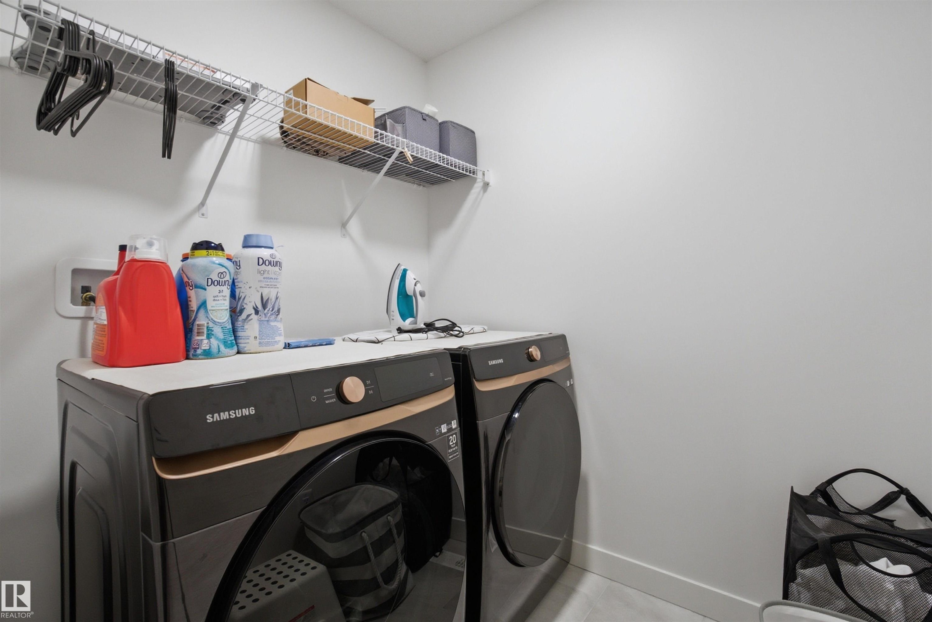 Laundry area with baseboards and washer and dryer - 9882 225A St Nw, Edmonton, AB - Indoor Photo Showing Laundry Room