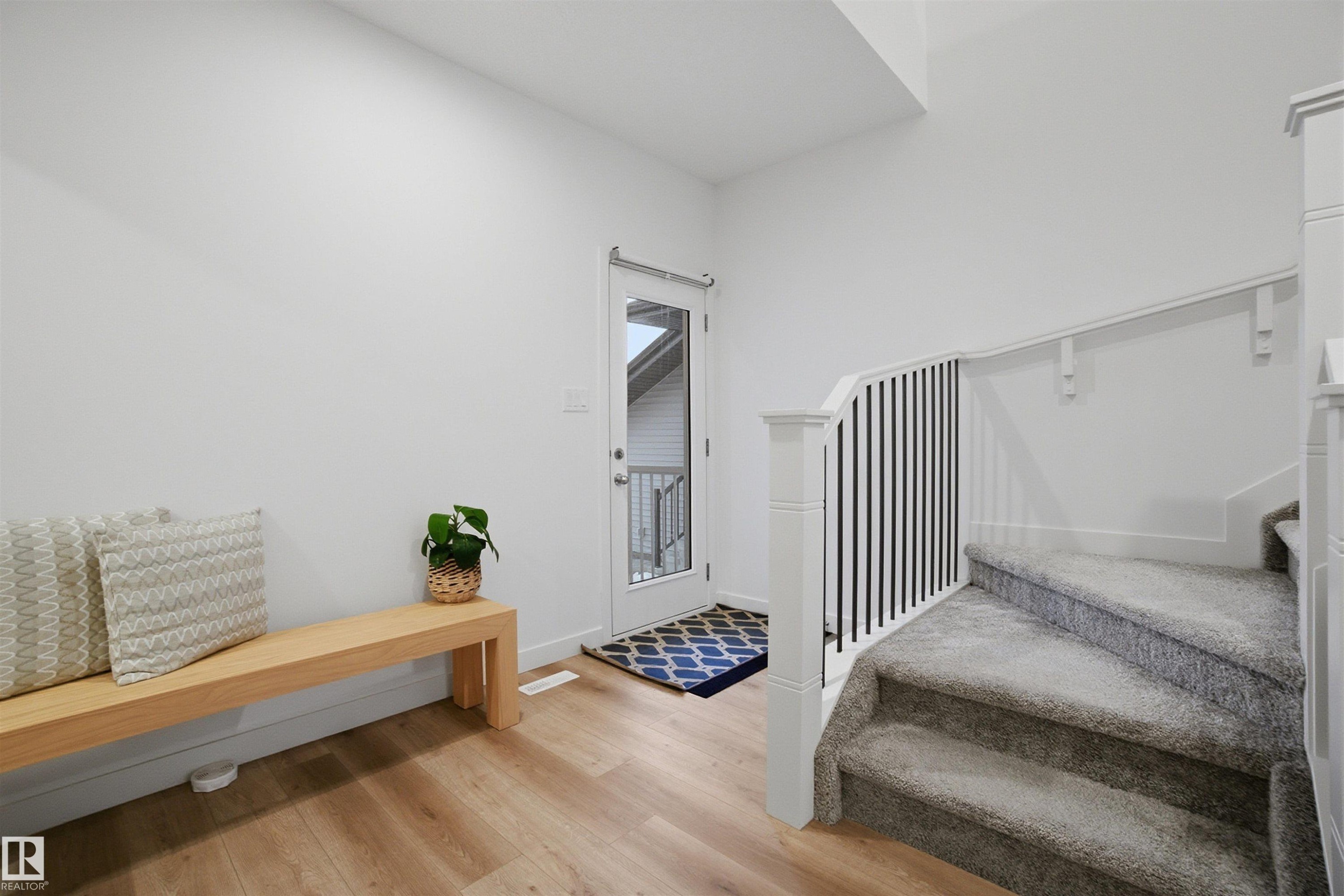 Stairway featuring wood finished floors and baseboards - 9882 225A St Nw, Edmonton, AB - Indoor