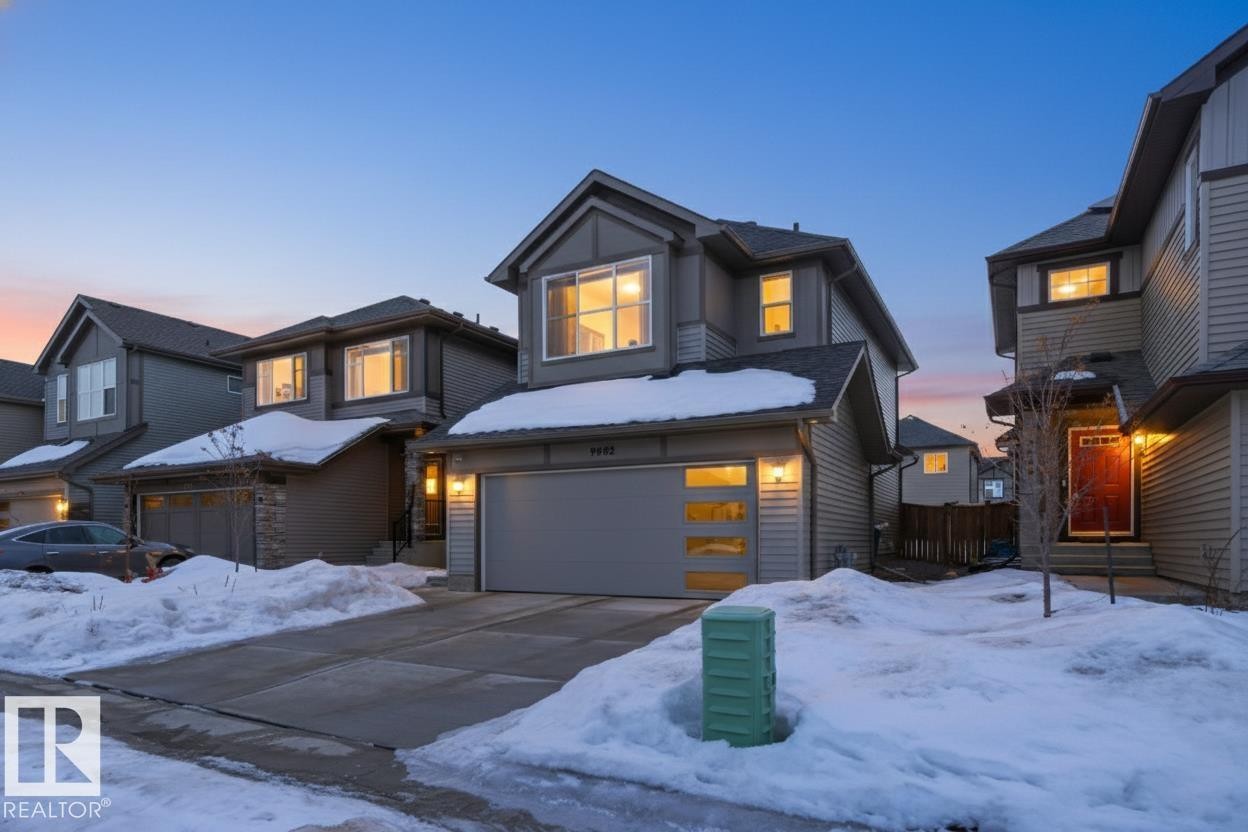 View of front of home with an attached garage and concrete driveway - 9882 225A St Nw, Edmonton, AB - Outdoor With Facade