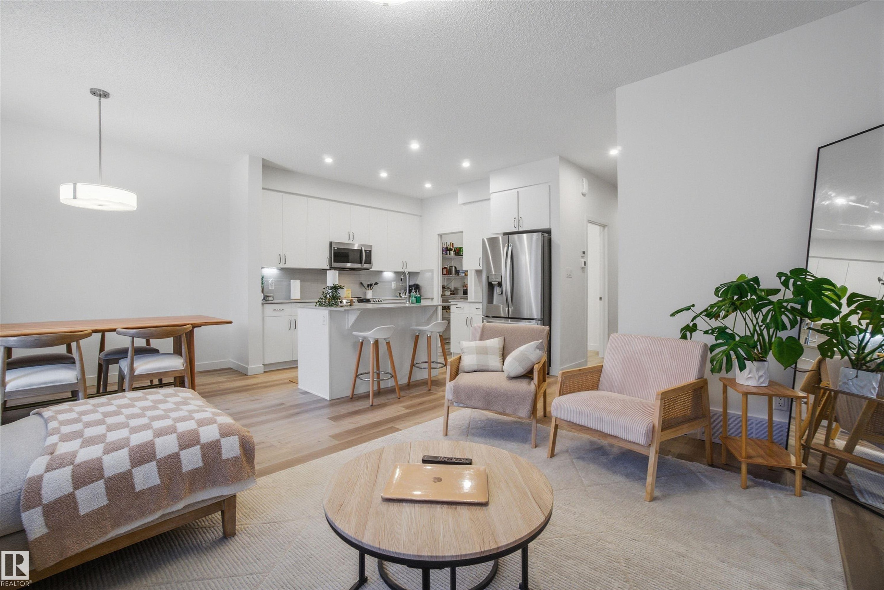Living area with light wood-style floors, recessed lighting, and a textured ceiling - 9882 225A St Nw, Edmonton, AB - Indoor Photo Showing Living Room