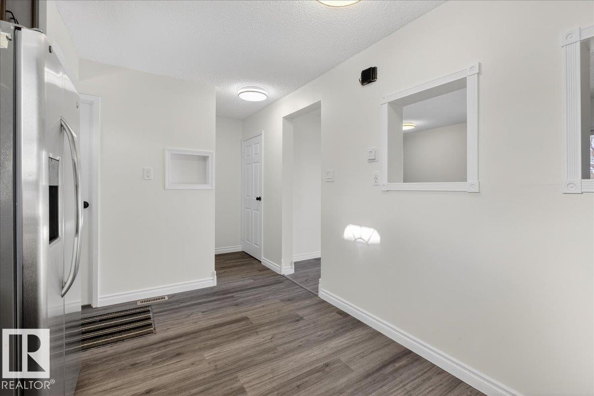 Corridor featuring a textured ceiling and wood finished floors - 133 Habitat Crescent, Edmonton, AB - Indoor Photo Showing Other Room