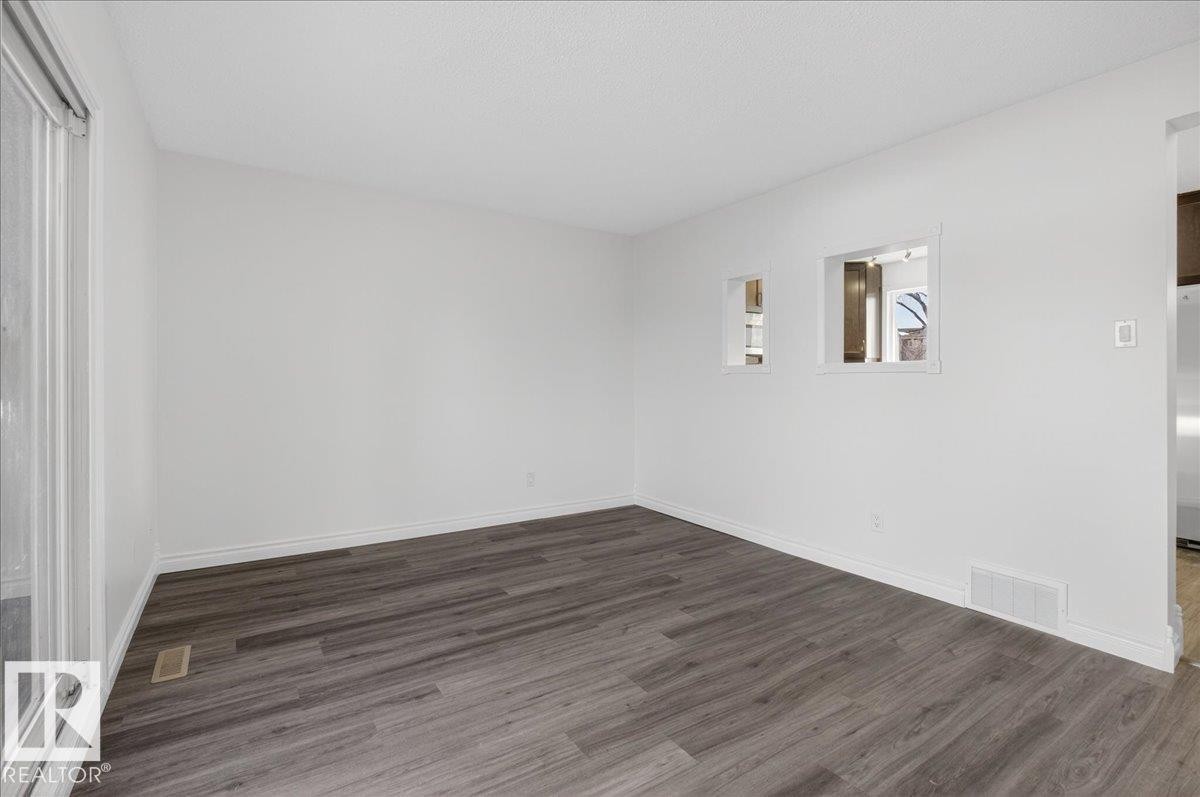 Unfurnished room with dark wood-style floors and baseboards - 133 Habitat Crescent, Edmonton, AB - Indoor Photo Showing Other Room