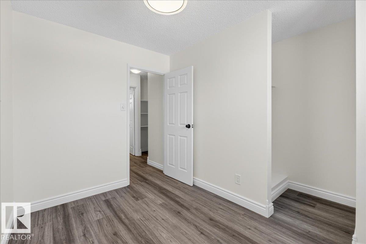 Unfurnished room featuring a textured ceiling and wood finished floors - 133 Habitat Crescent, Edmonton, AB - Indoor Photo Showing Other Room