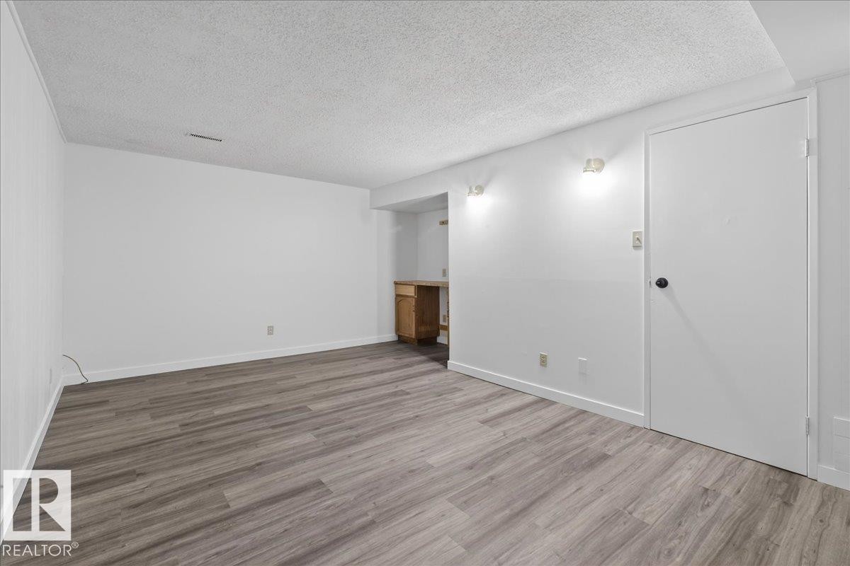 Spare room featuring a textured ceiling and light wood-style flooring - 133 Habitat Crescent, Edmonton, AB - Indoor Photo Showing Other Room