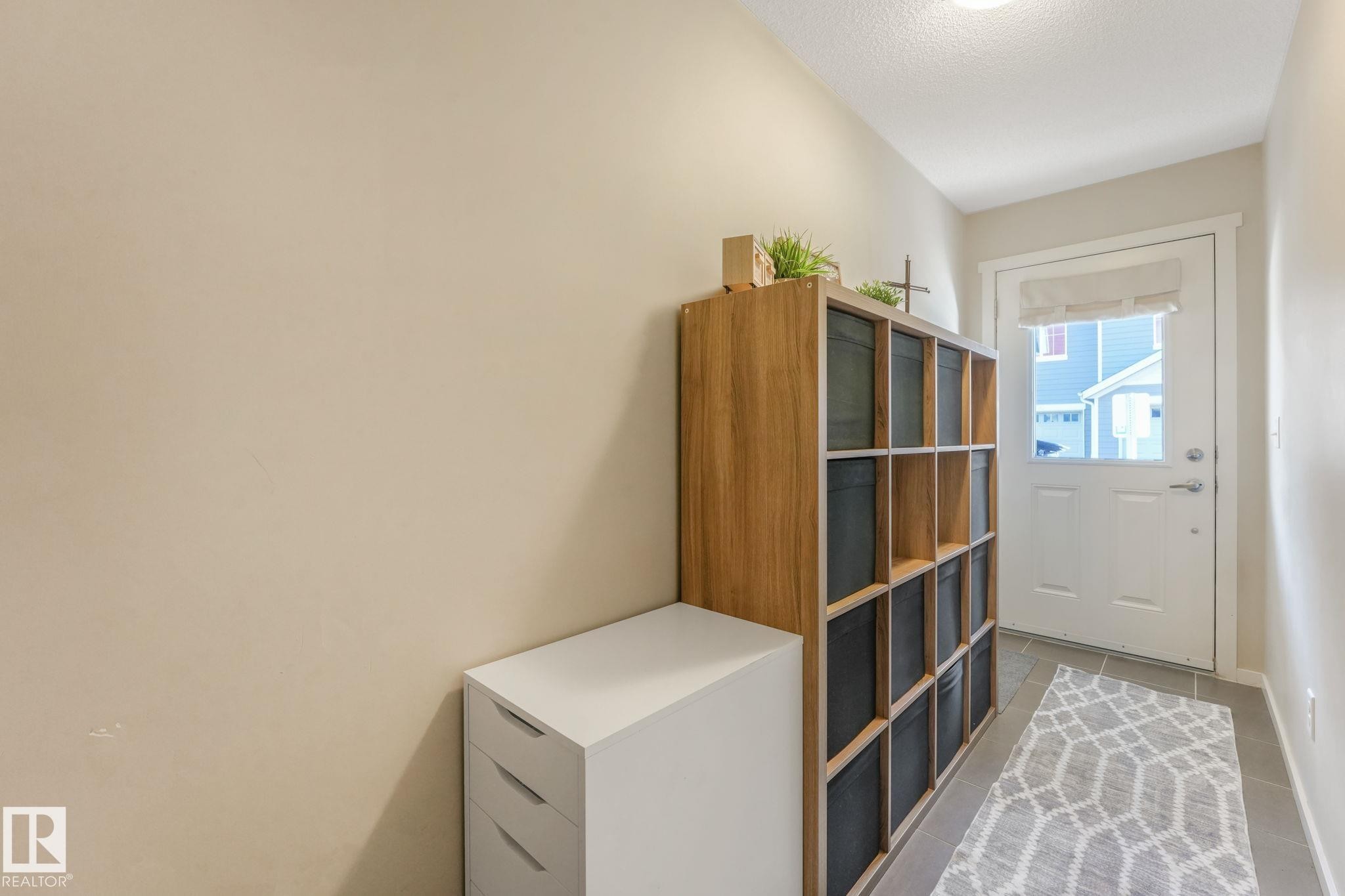 Entryway with tile patterned flooring and a textured ceiling - 91 603 Watt Boulevard, Edmonton, AB - Indoor