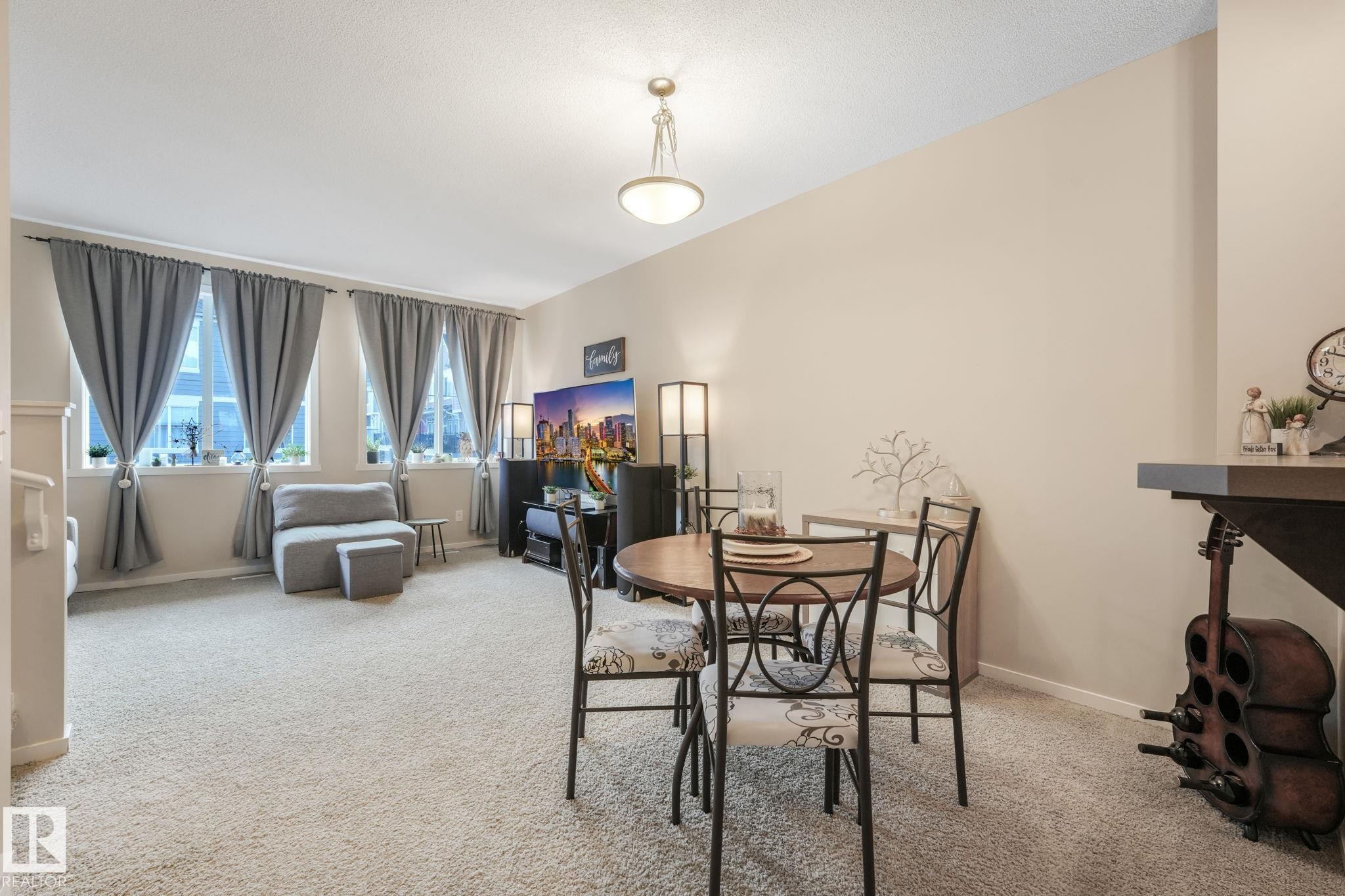 Dining area with light colored carpet and baseboards - 91 603 Watt Boulevard, Edmonton, AB - Indoor