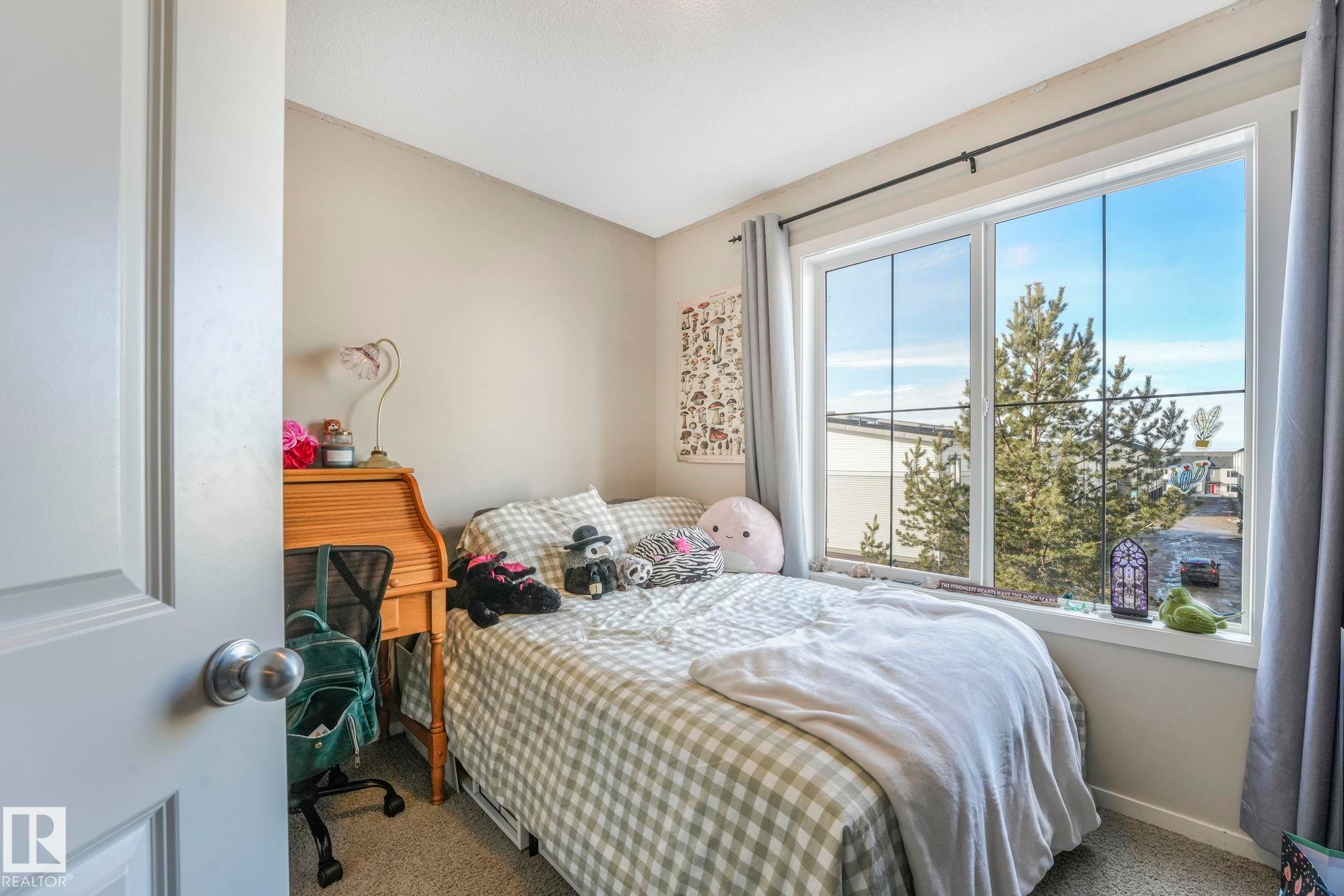 Carpeted bedroom featuring baseboards - 91 603 Watt Boulevard, Edmonton, AB - Indoor Photo Showing Bedroom