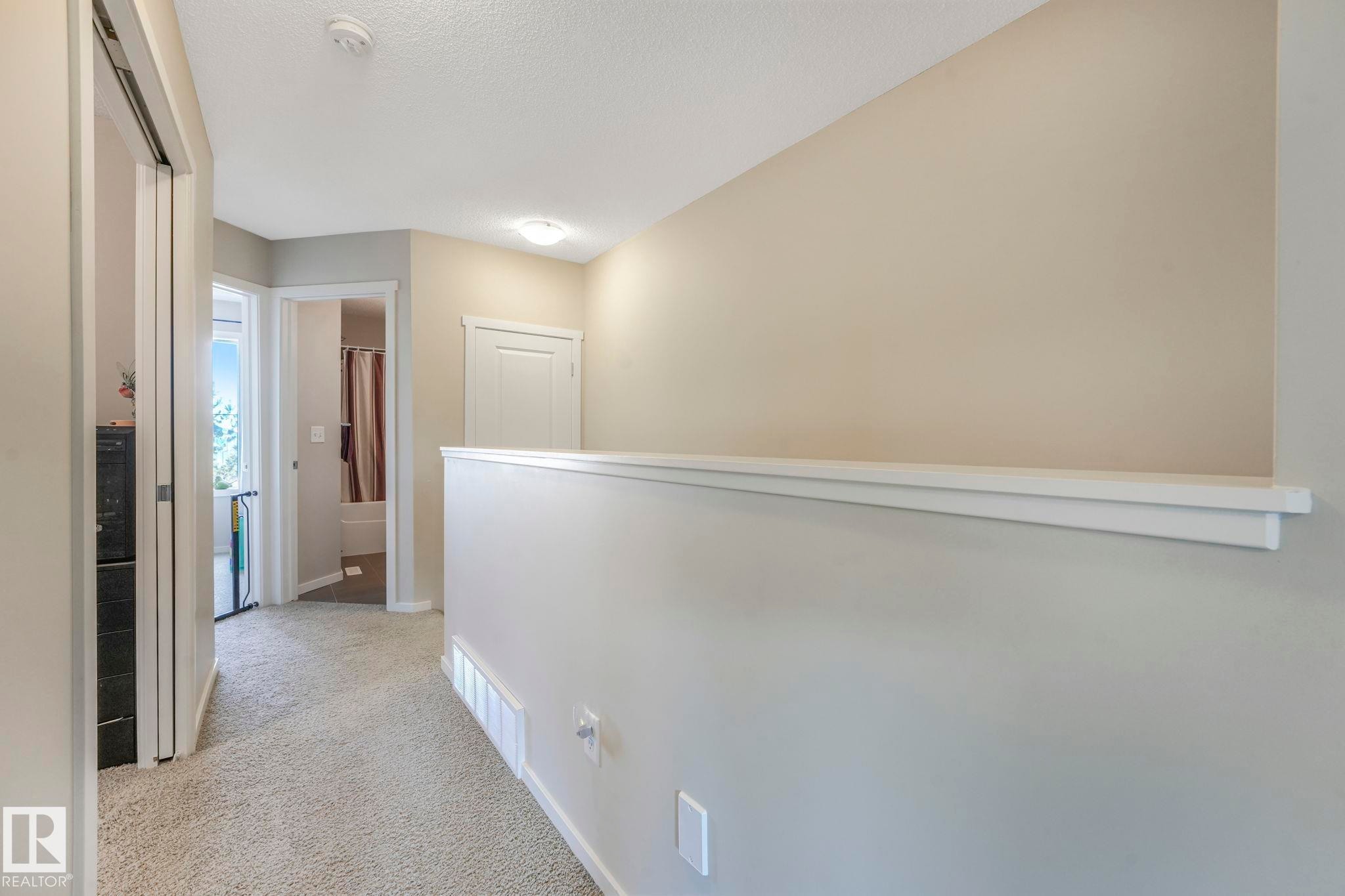 Hallway with light colored carpet and baseboards - 91 603 Watt Boulevard, Edmonton, AB - Indoor Photo Showing Other Room