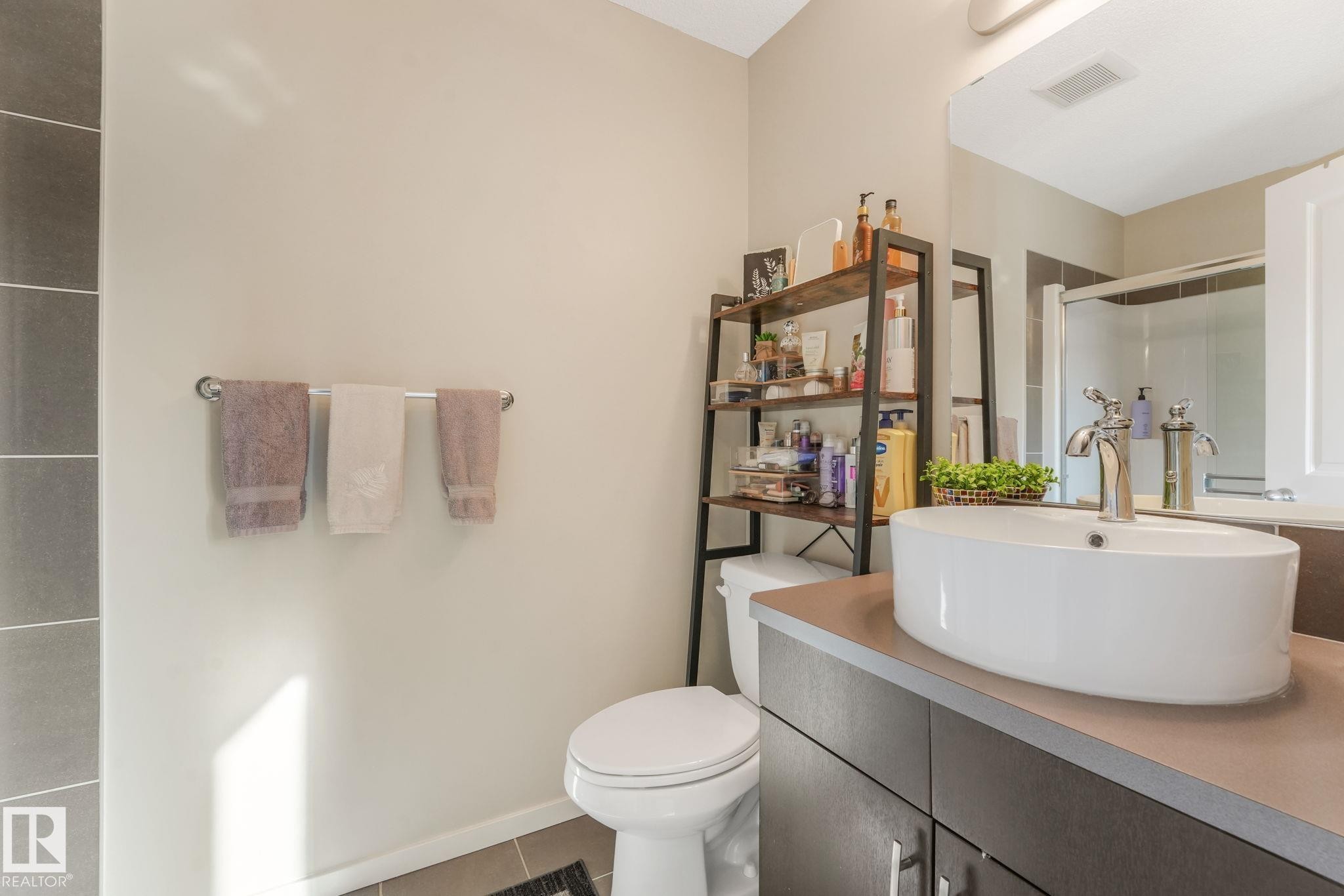 Full bath with vanity, tile patterned floors, and a shower with shower door - 91 603 Watt Boulevard, Edmonton, AB - Indoor Photo Showing Bathroom