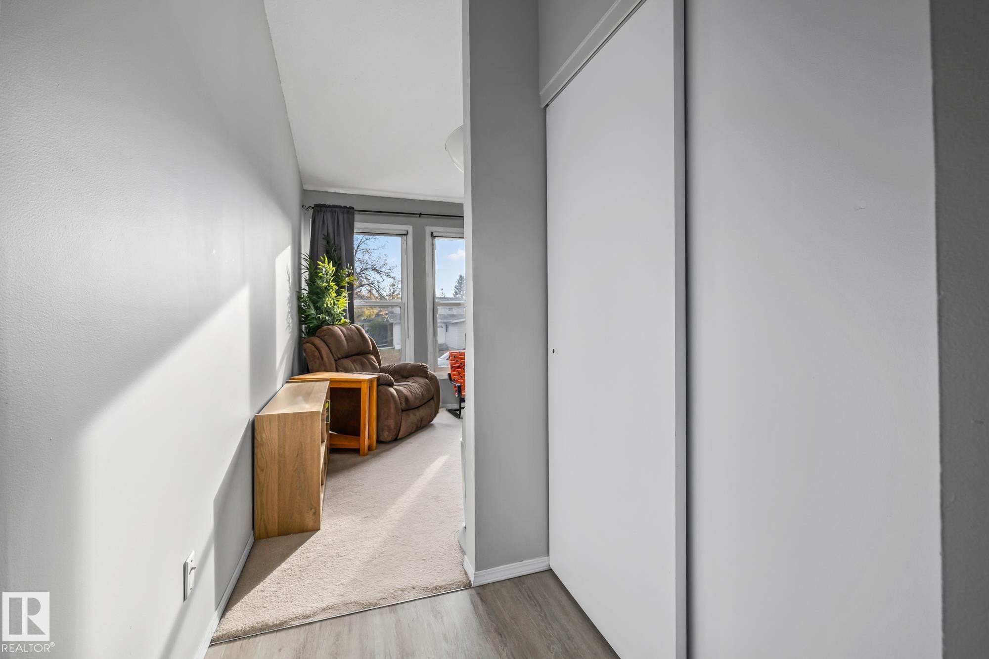 Hall with light wood finished floors and baseboards - 11 Grandview Ridge, St. Albert, AB - Indoor Photo Showing Other Room