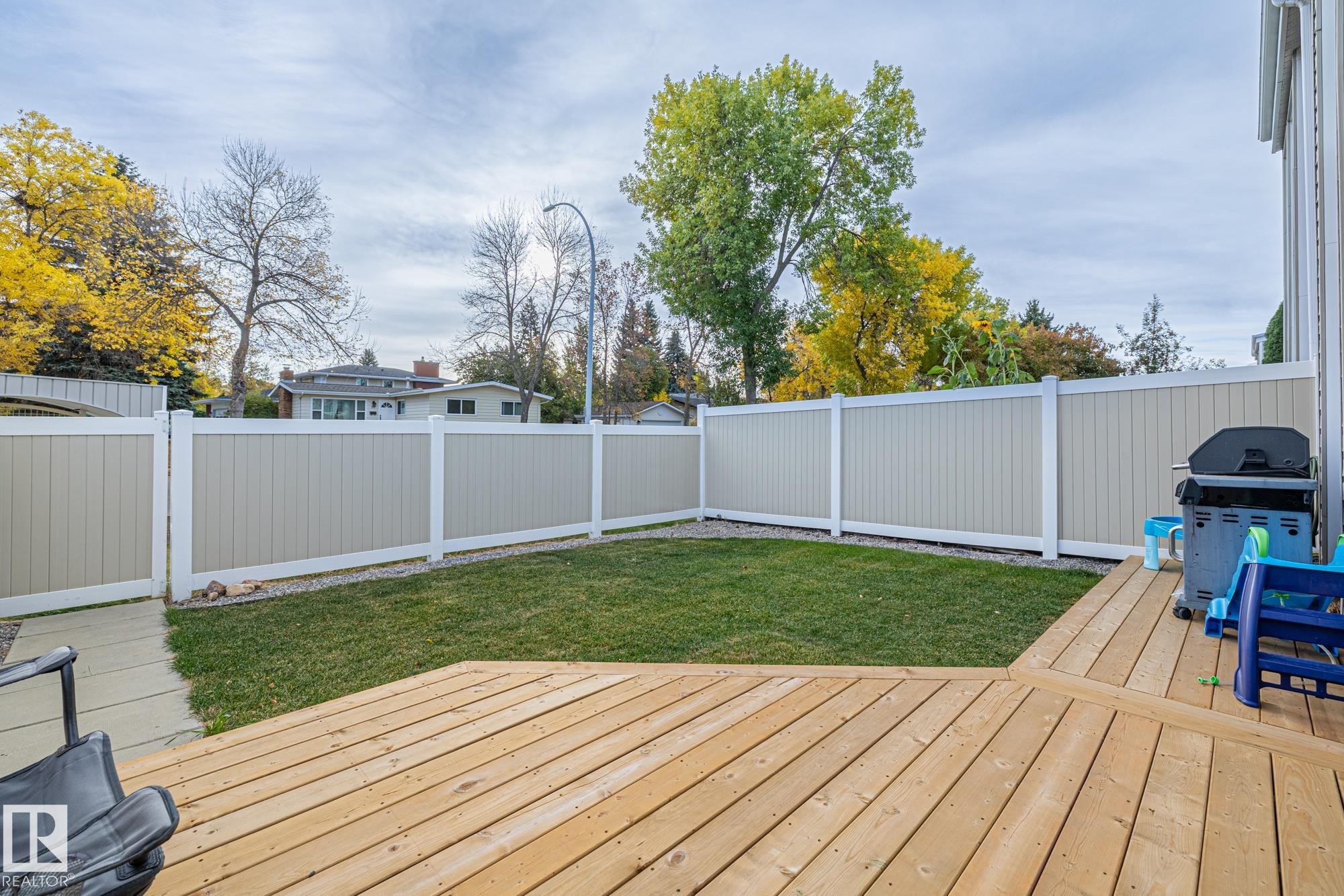 Wooden deck with a fenced backyard and grilling area - 11 Grandview Ridge, St. Albert, AB - Outdoor With Deck Patio Veranda