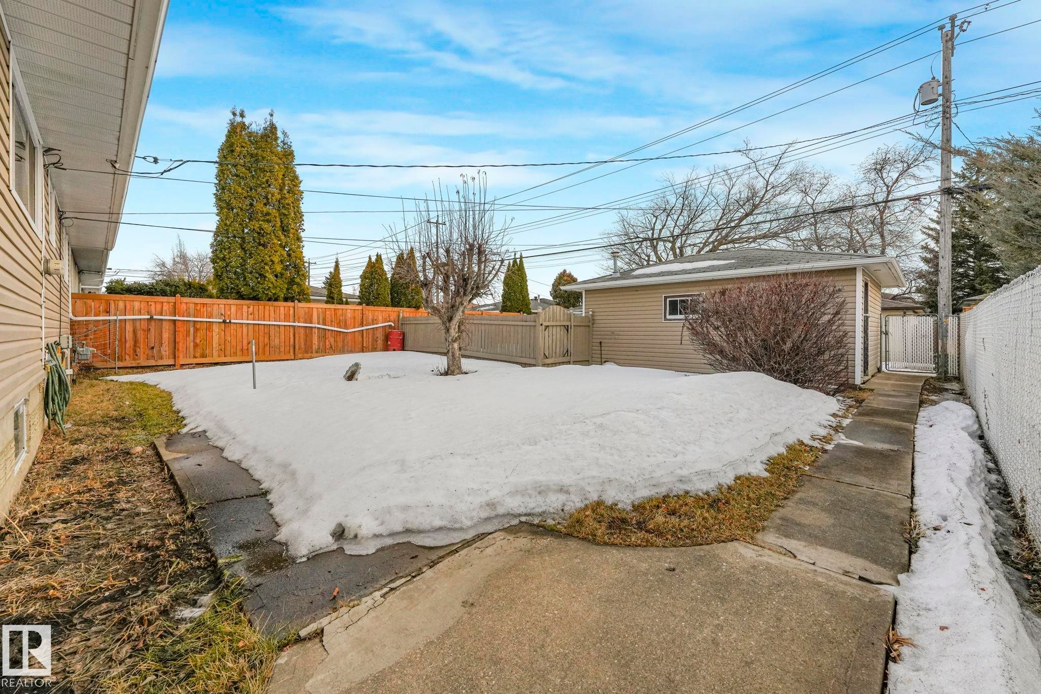 Yard layered in snow featuring a fenced backyard - 6007 95 Avenue, Edmonton, AB - Outdoor