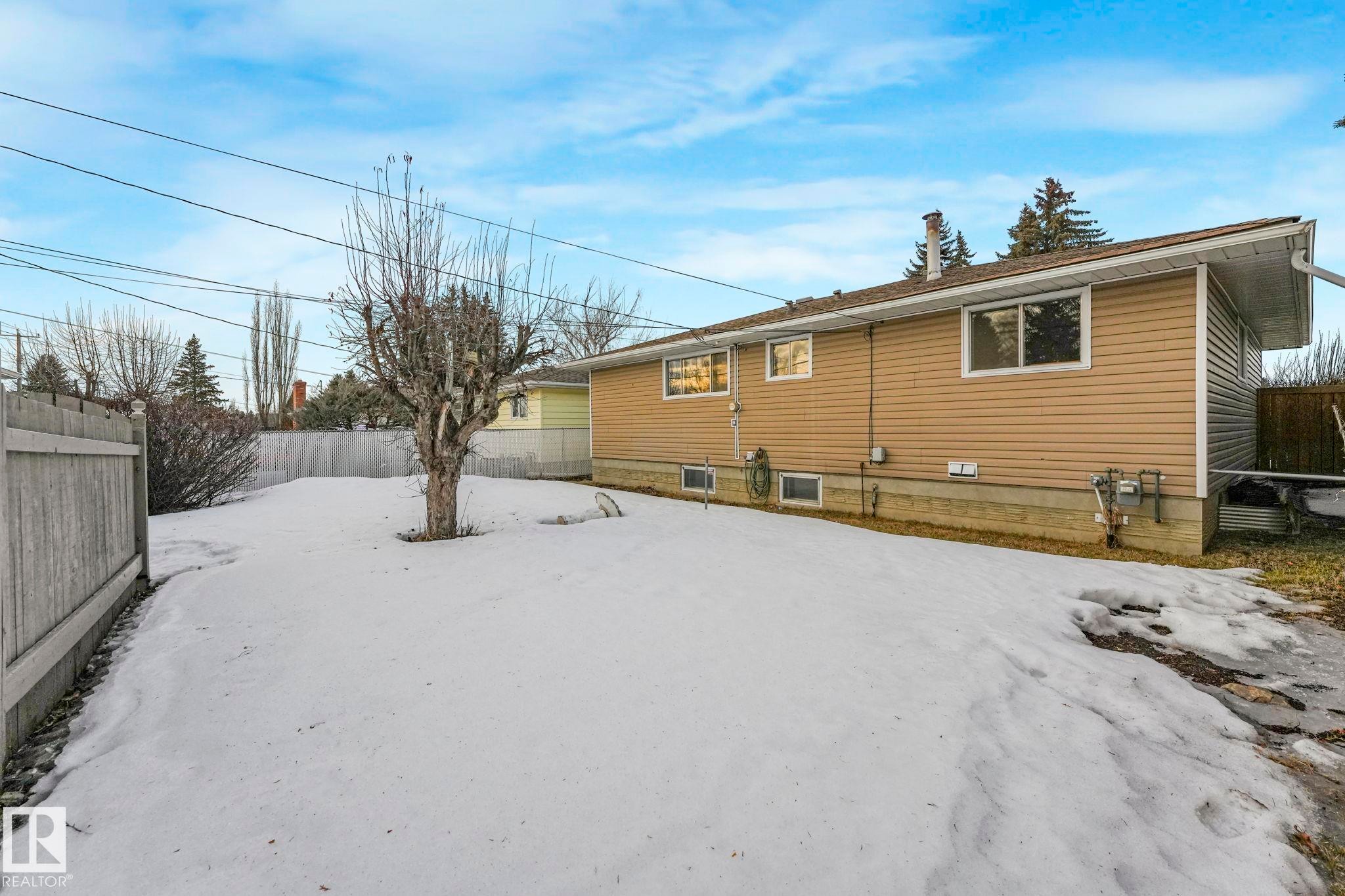 Snow covered property featuring a fenced backyard - 6007 95 Avenue, Edmonton, AB - Outdoor
