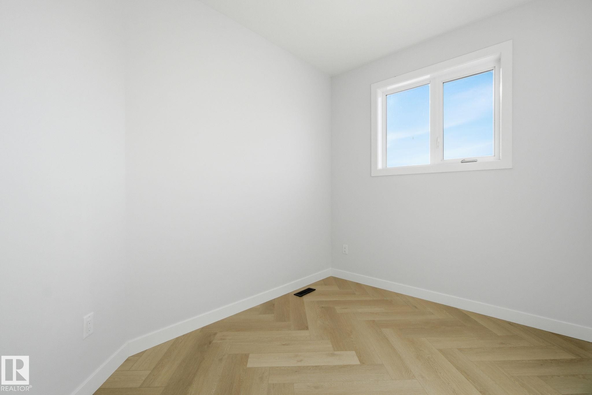 Spare room with parquet flooring and baseboards - 17108 2 Street, Edmonton, AB - Indoor Photo Showing Other Room