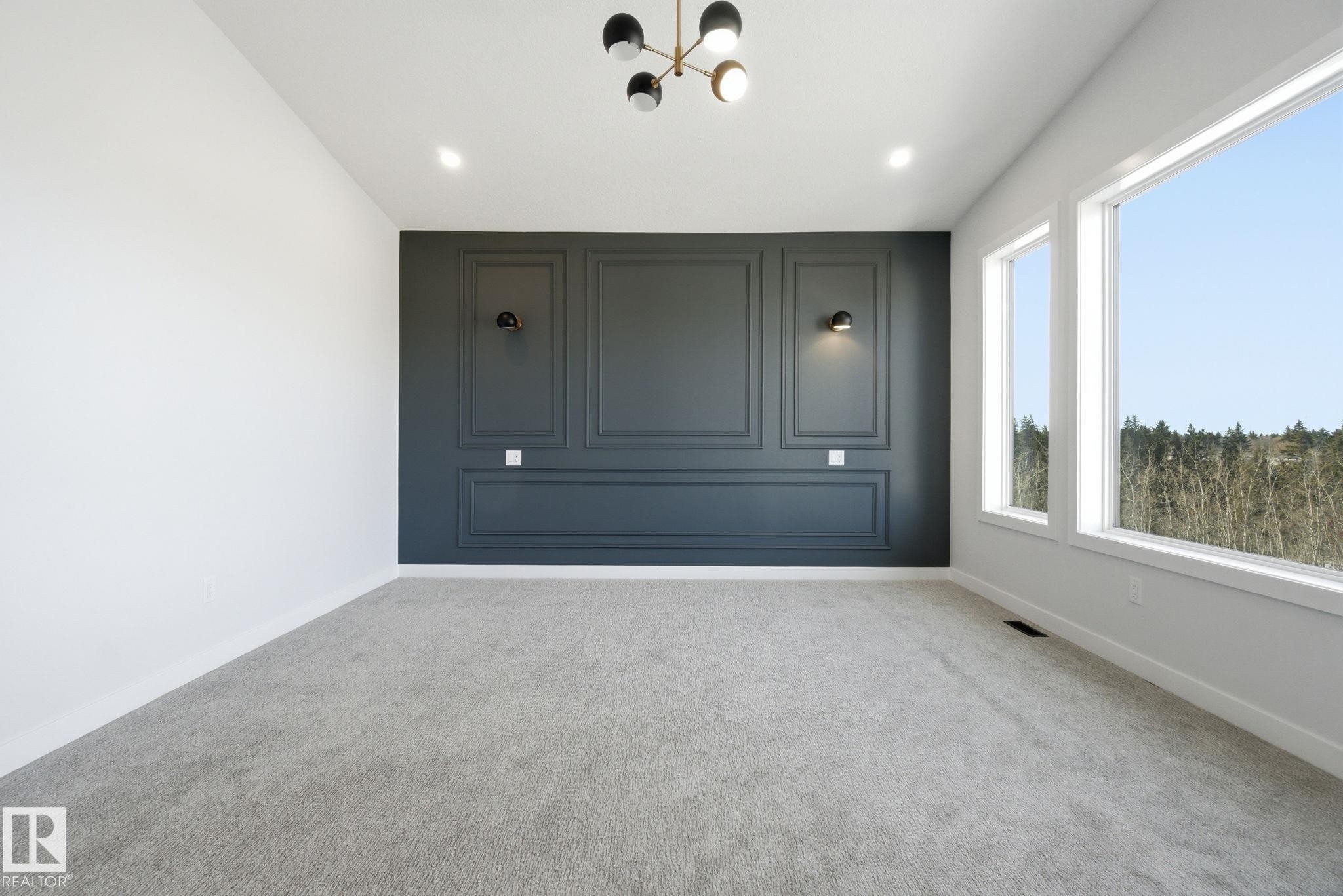 Empty room with carpet floors and a chandelier - 17108 2 Street, Edmonton, AB - Indoor Photo Showing Other Room