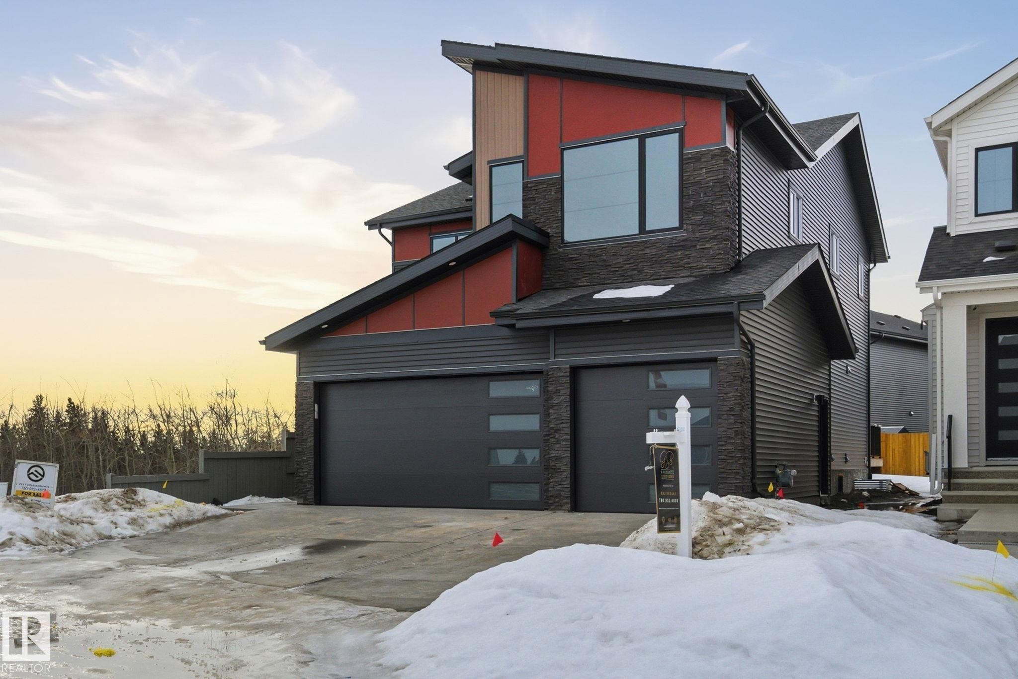 Contemporary home featuring stone siding, board and batten siding, and a garage - 17108 2 Street, Edmonton, AB - Outdoor