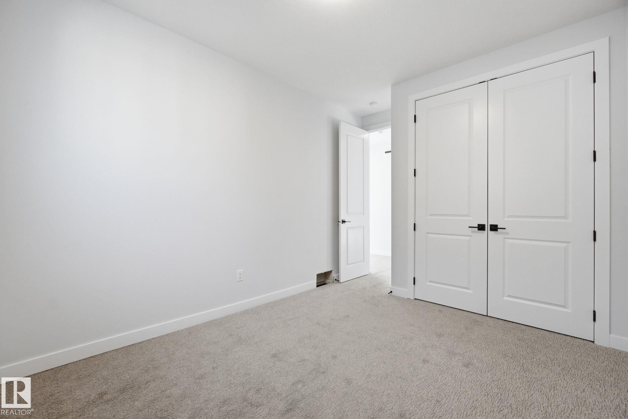 Unfurnished bedroom featuring carpet floors and a closet - 17108 2 Street, Edmonton, AB - Indoor Photo Showing Other Room