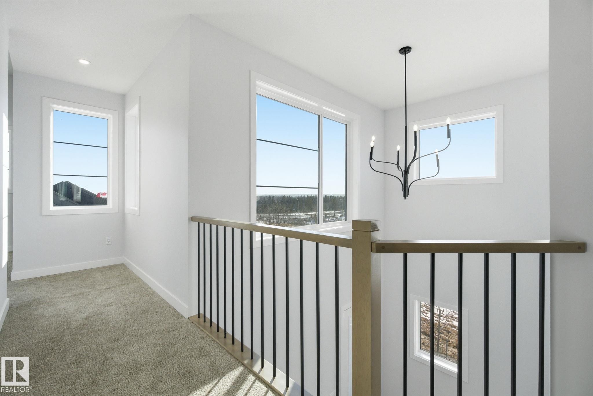 Hall featuring light carpet and suspended lighting - 17108 2 Street, Edmonton, AB - Indoor Photo Showing Other Room