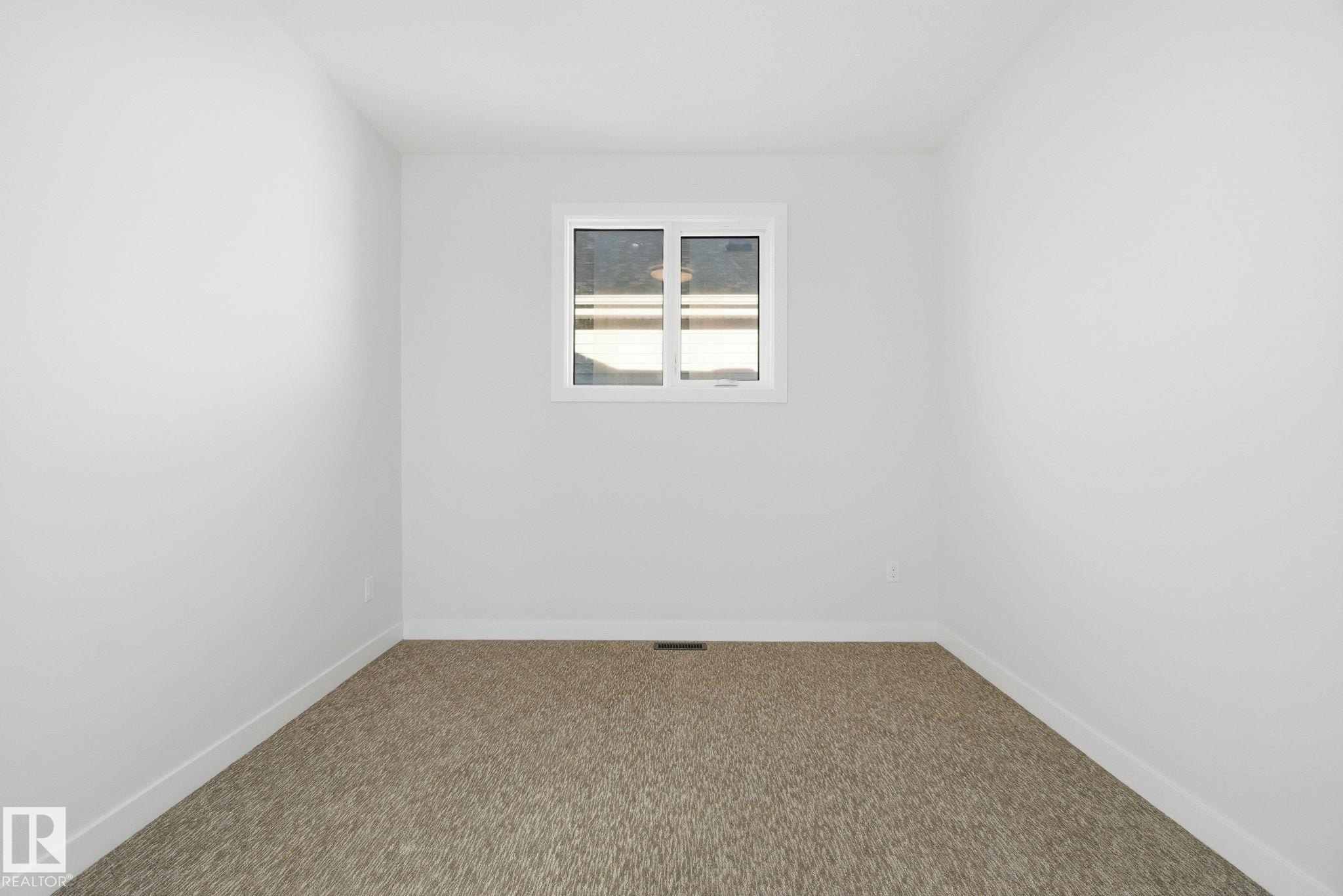Unfurnished room featuring baseboards and carpet flooring - 17108 2 Street, Edmonton, AB - Indoor Photo Showing Other Room