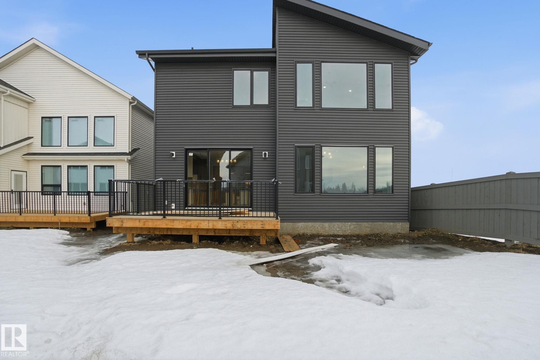 Snow covered back of property featuring a wooden deck - 17108 2 Street, Edmonton, AB - Outdoor