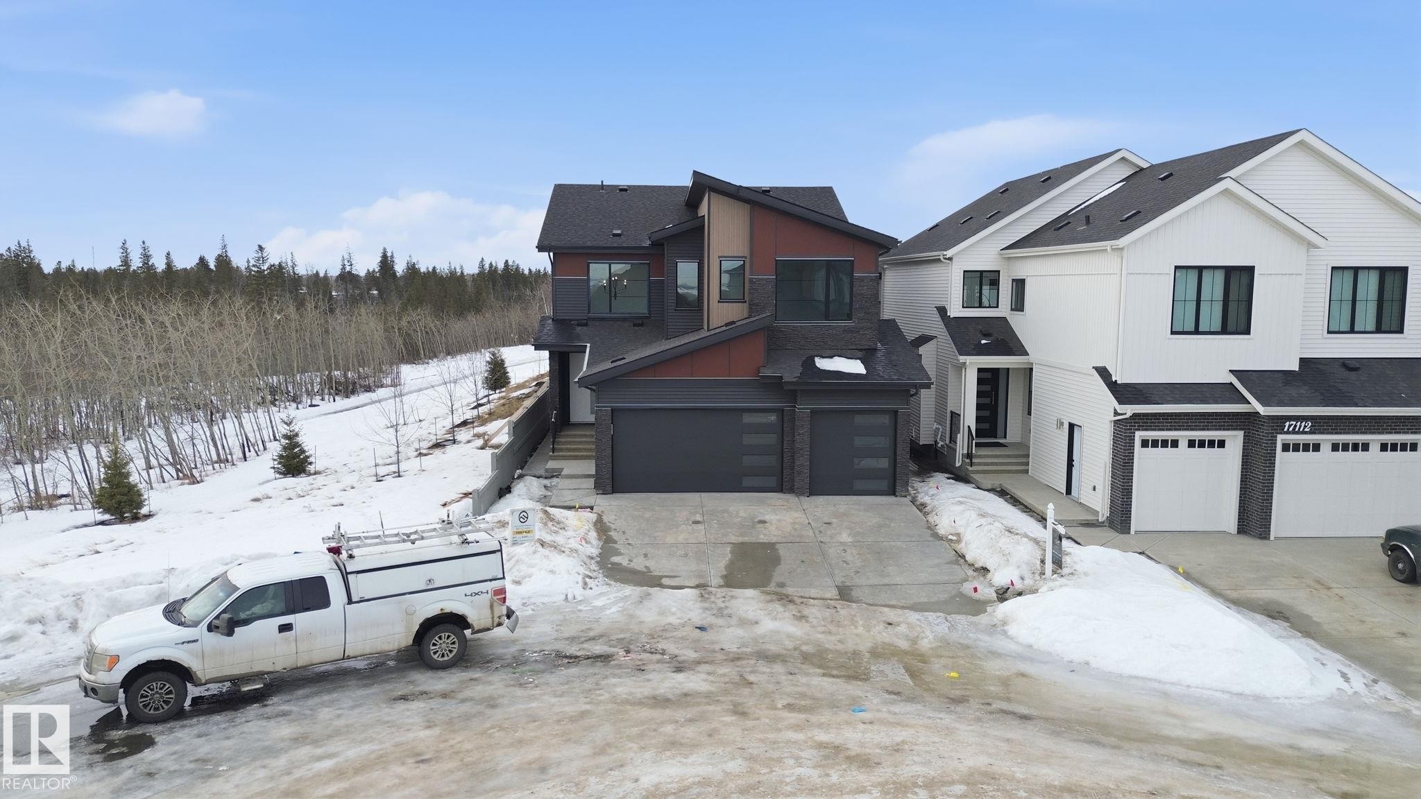 View of front of home with a garage, roof with shingles, and concrete driveway - 17108 2 Street, Edmonton, AB - Outdoor With Facade