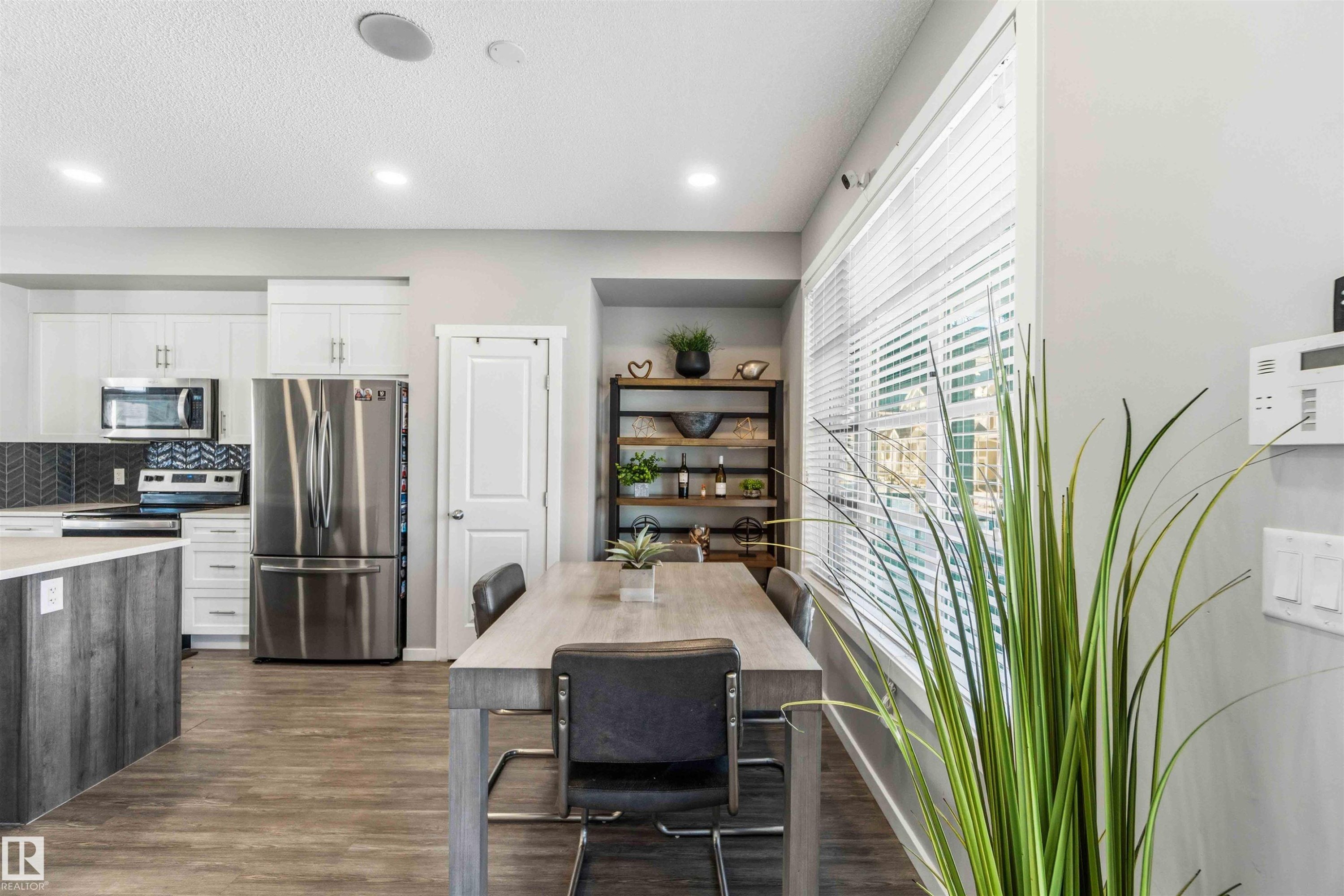 Dining space featuring dark wood-style flooring and recessed lighting - 1908 25 Street, Edmonton, AB - Indoor Photo Showing Kitchen With Stainless Steel Kitchen